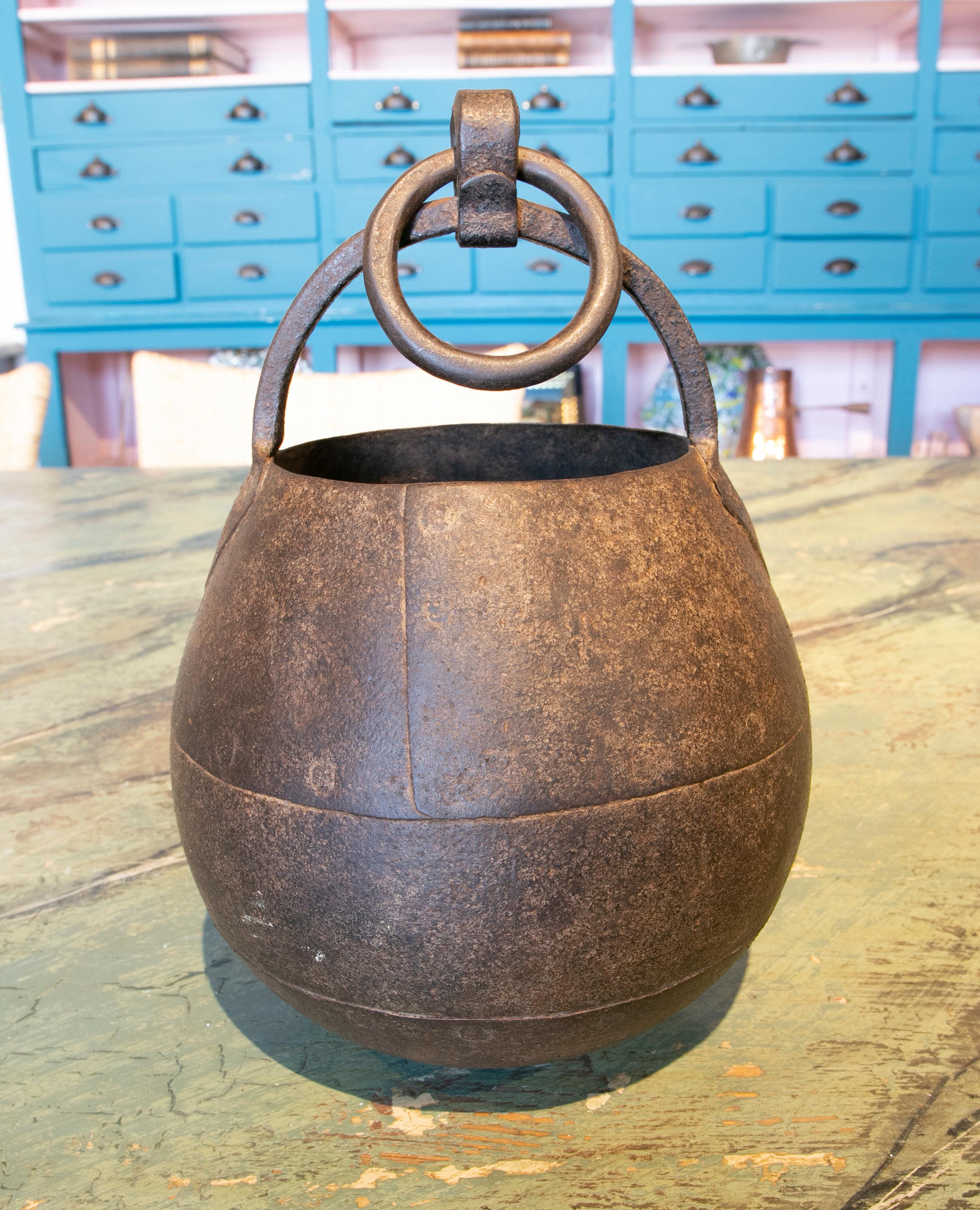 19th century ball-shaped iron box with hook for hanging.
