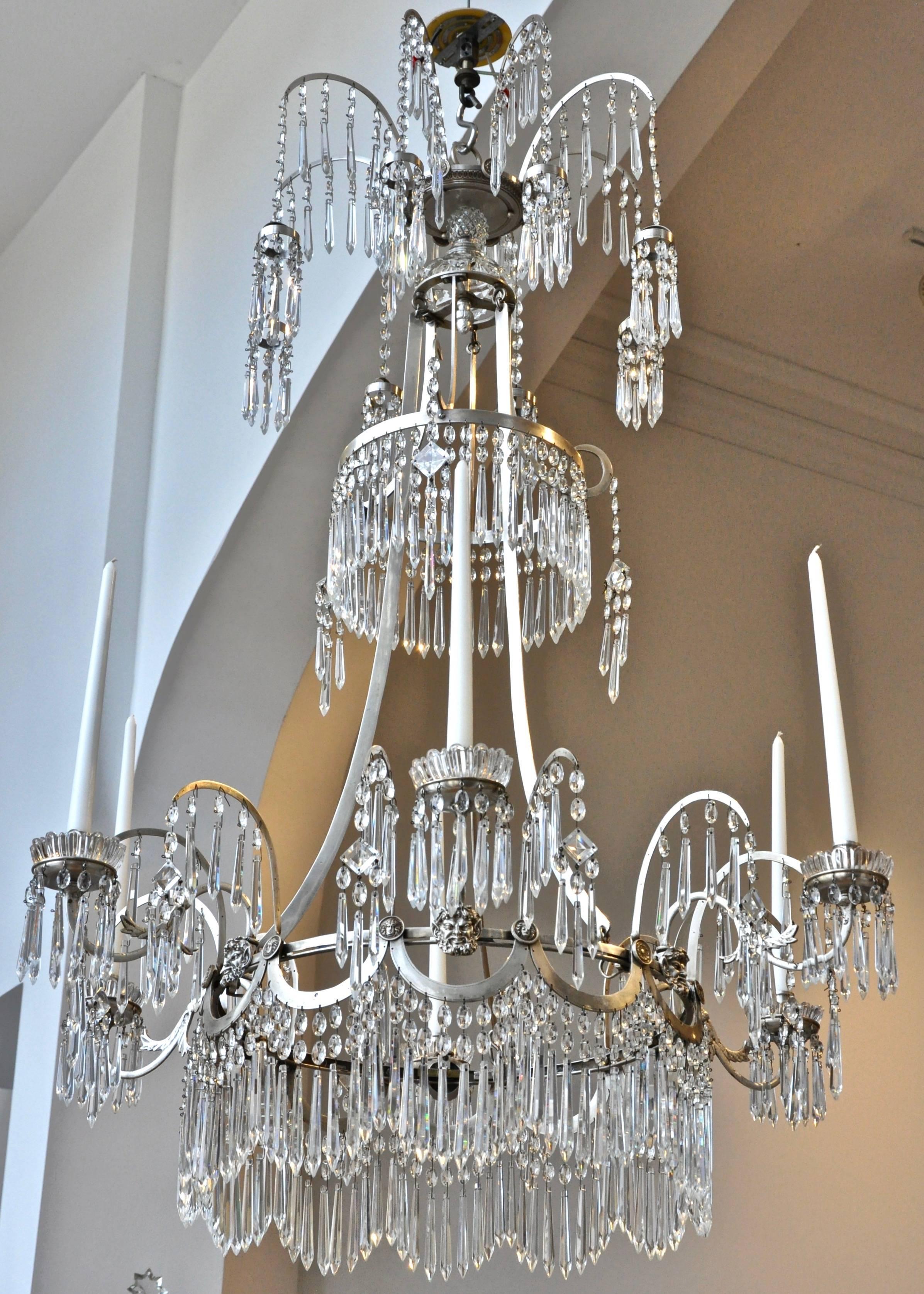 Beautiful 19th century silvered neoclassical chandelier.

- Palm frond motif with satyr masks and medusa plaques
- Original crystals
- Silver plate or nickel silver feels roman in its quality. Now lacquered as to not tarnish
- Can be French