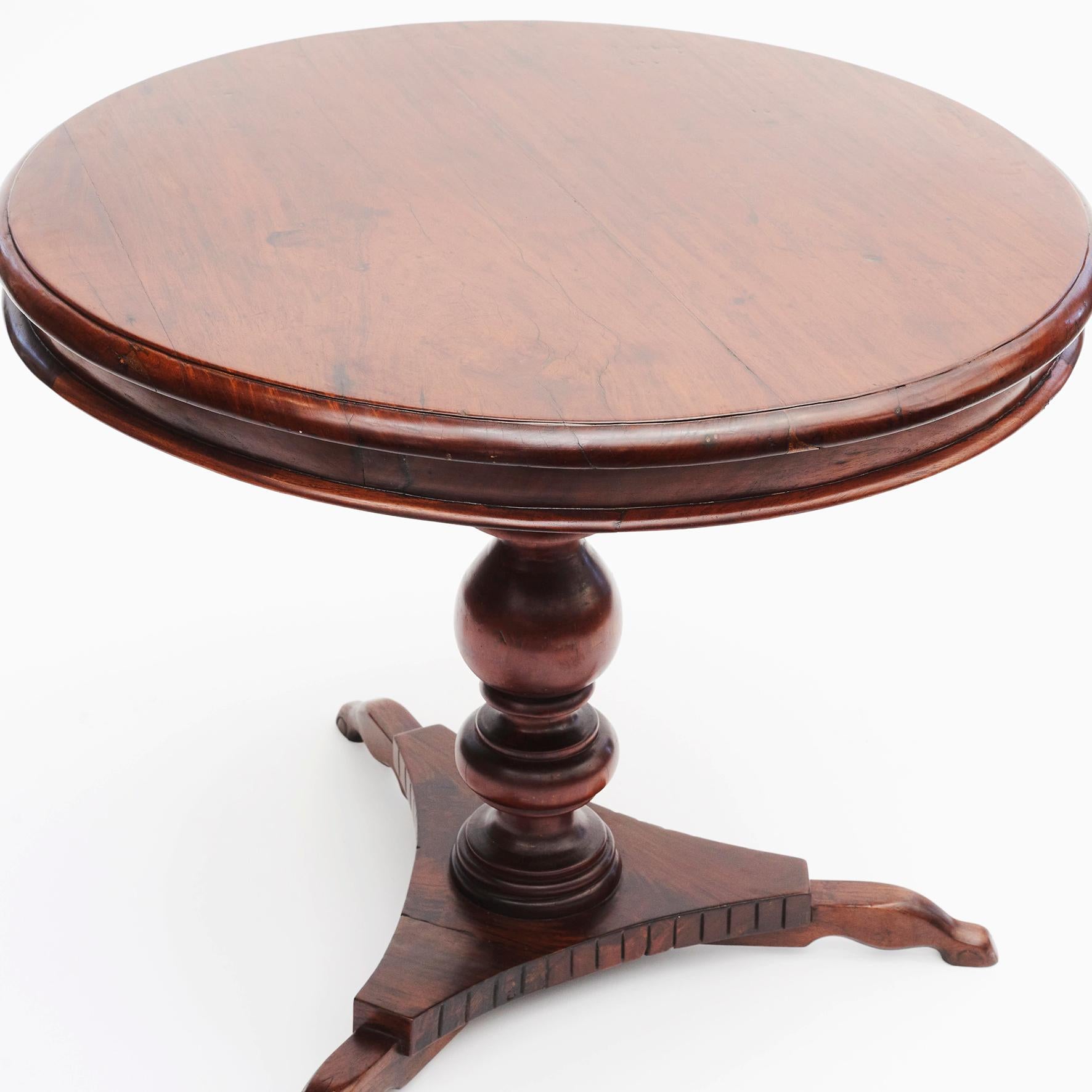 Baluster center table in Narra hardwood with beautiful grain.
Circular top above baluster turned column and triform base.
 
Narra hardwood is a totally protected species and the Philippines national tree – with a very beautiful grain.
The