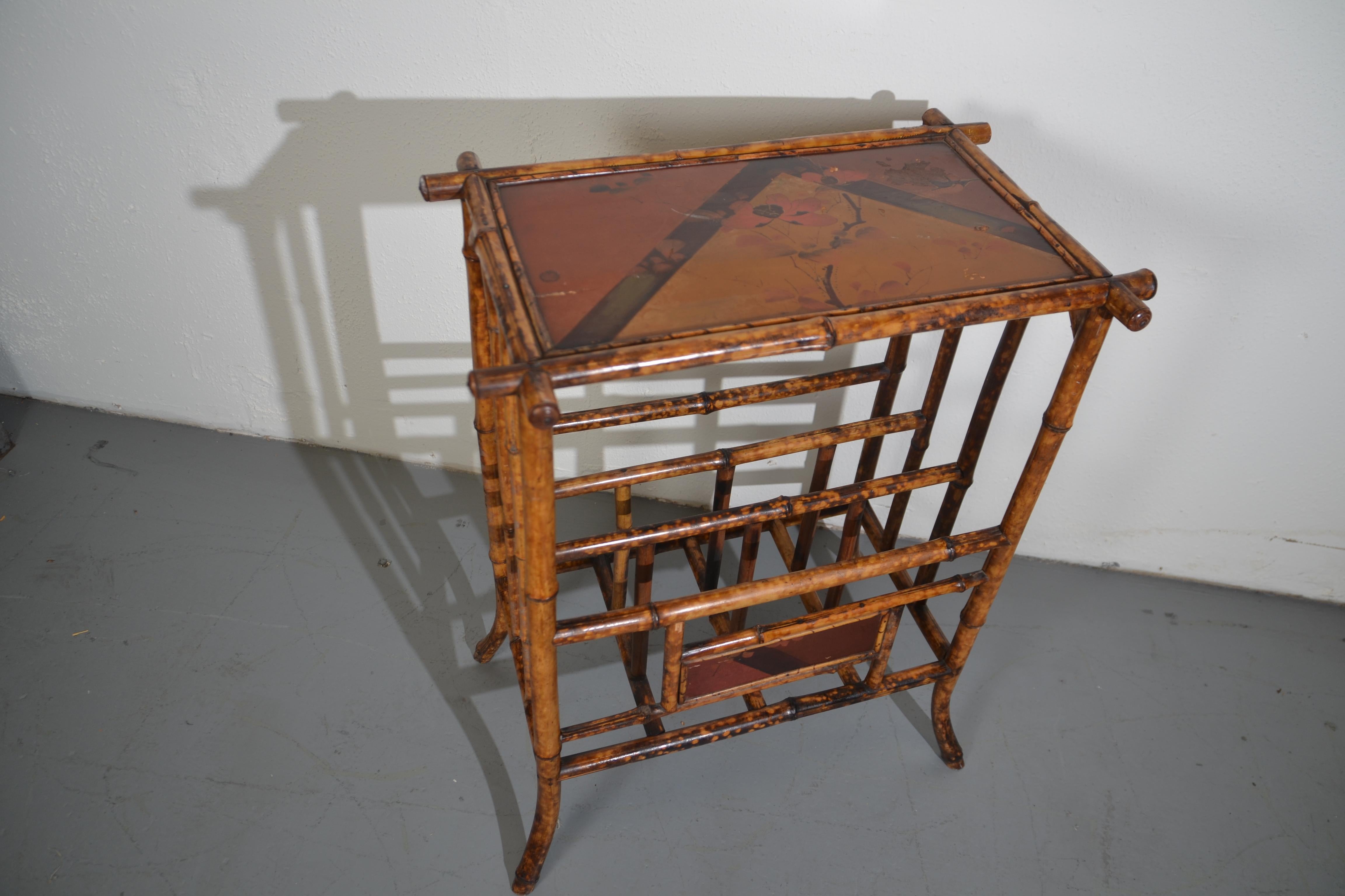 19th Century Bamboo accent table with storage racks below. The racks are the perfect size for magazines and other media.