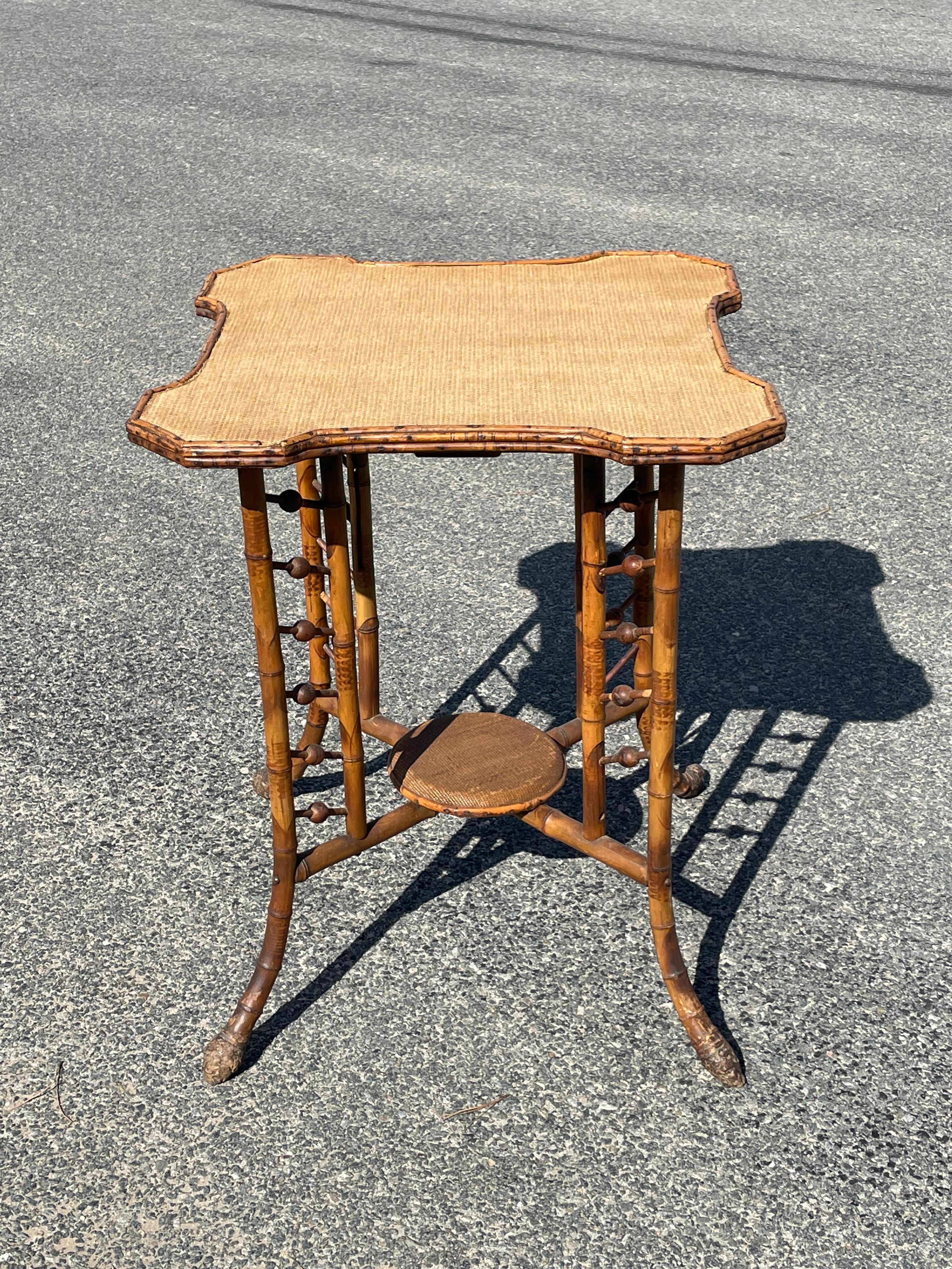 Lovely 19th century bamboo side table with cut corners and grasscloth (newer replacement) top, decorative stick and ball openwork base.