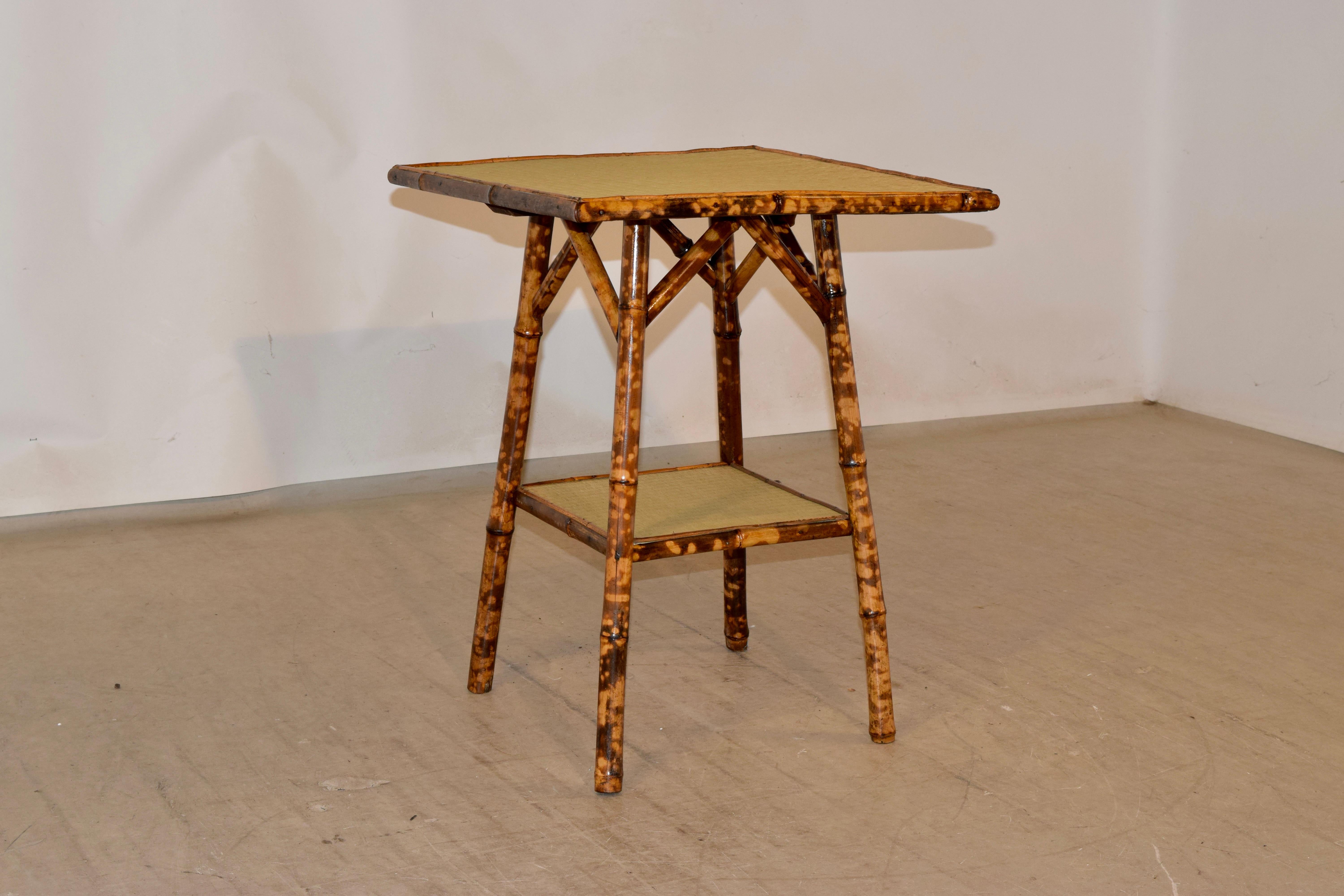19th century tortoise bamboo side table with rush covered top and lower shelf.