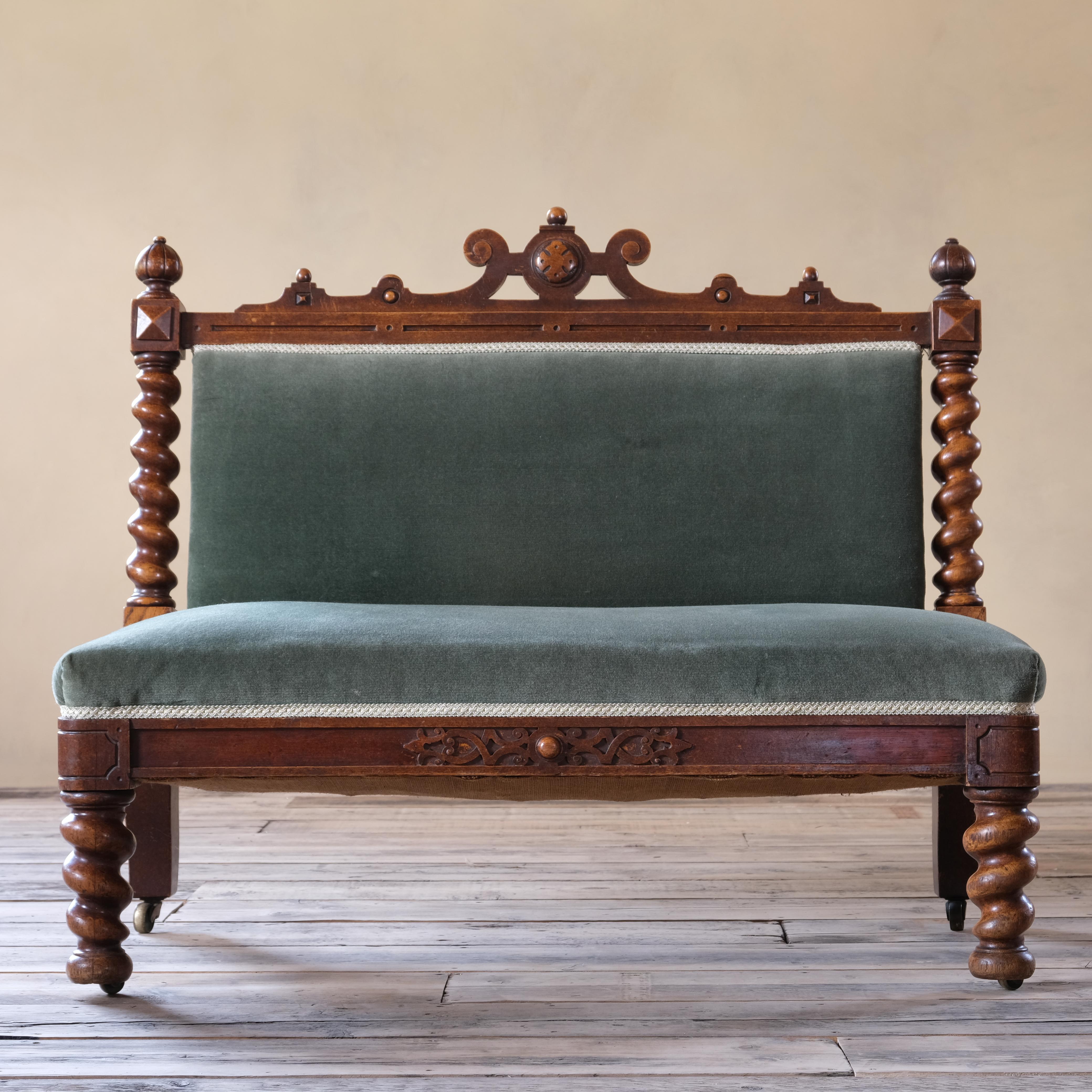 A 19th century oak 2 seater bench with barley twist legs and back supports. fret work to the side rails and on its original Cope & Collinson brass casters. 

Upholstered in a green velvet. Structurally sound and ready for use. 

If you would