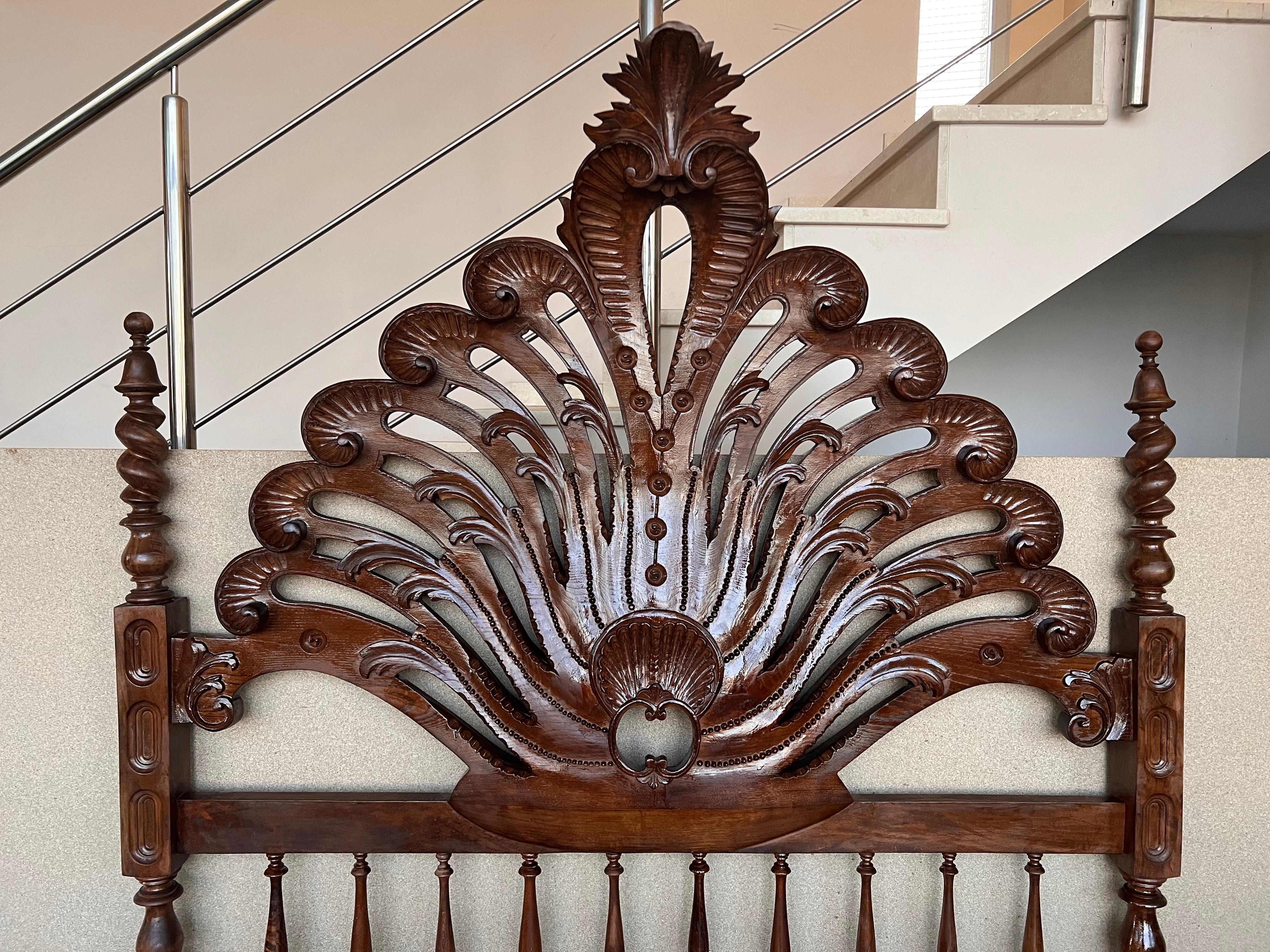 19th century Baroque bed, original Spanish bed.

This queen size 4-poster bed is hand carved with elaborate details, fluted turned post, 3D open spiral twist spindles, and Moorish details represented by the repetition of arches. It is carved and