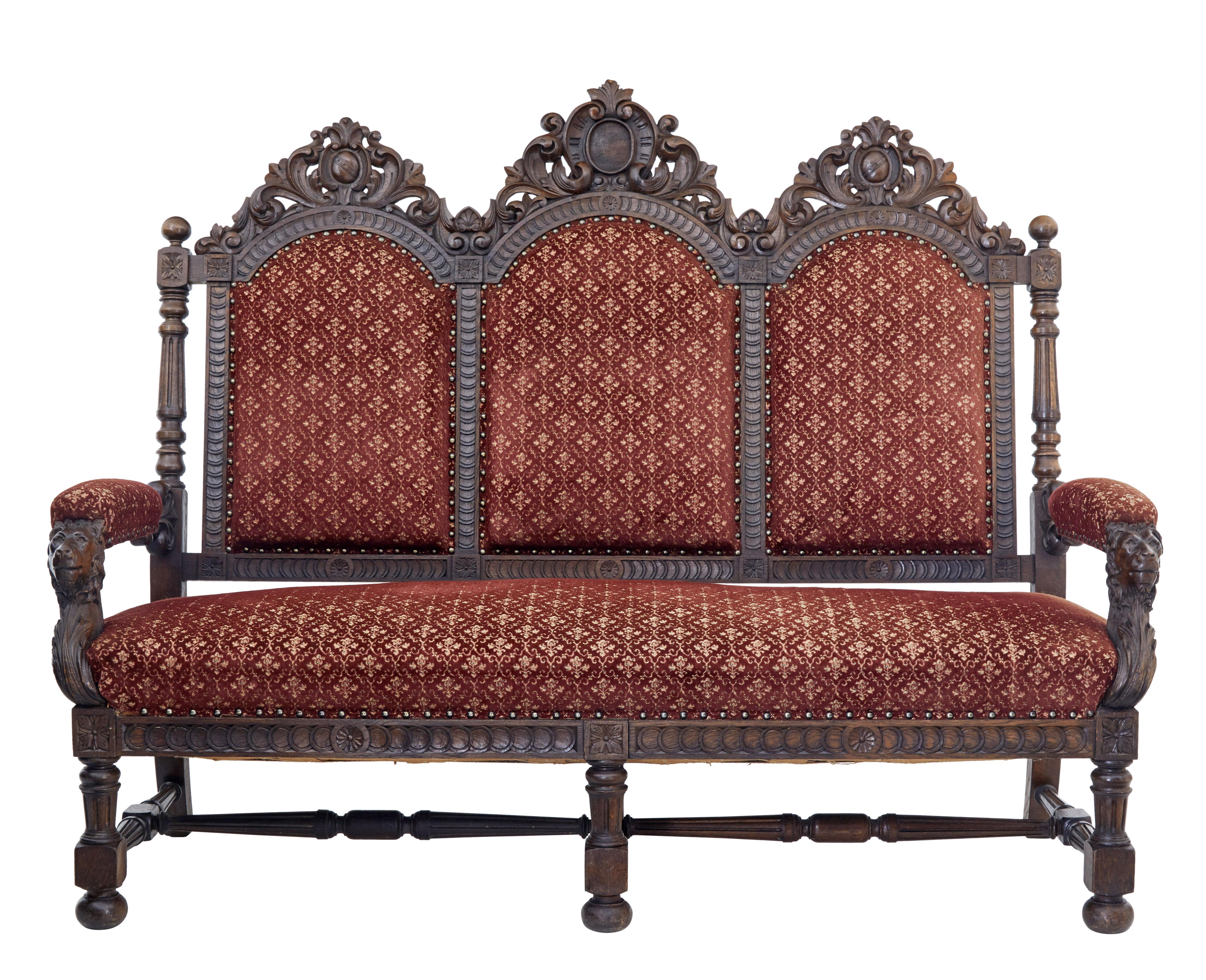 Heavily carved oak sofa, circa 1880.

3-seat sofa, with 3 back panels with heavily carved cartouche and swags on the backrest. 2 carved lions form the supports for the arm rests. Standing on 6 legs united by stretcher.

Upholstery is in good
