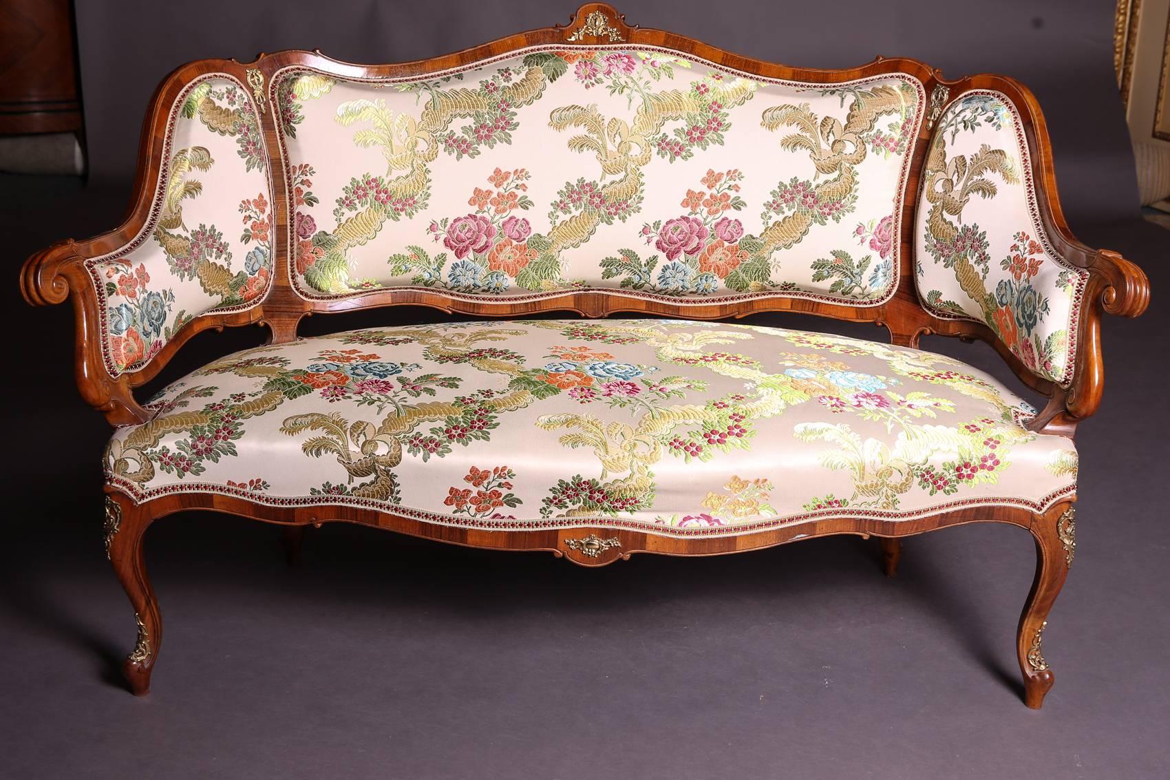 Four chairs with a sofa in Dresden baroque style. Walnut freed and felted. Rich gilded bronze appliqués, on the backs with perimeter bar contours. Saxony, circa 1880-1890.

Dimensions:
Canapé H 92 cm, W 149 cm, D 77
Chair H 93 cm, W 45 cm, D 47
