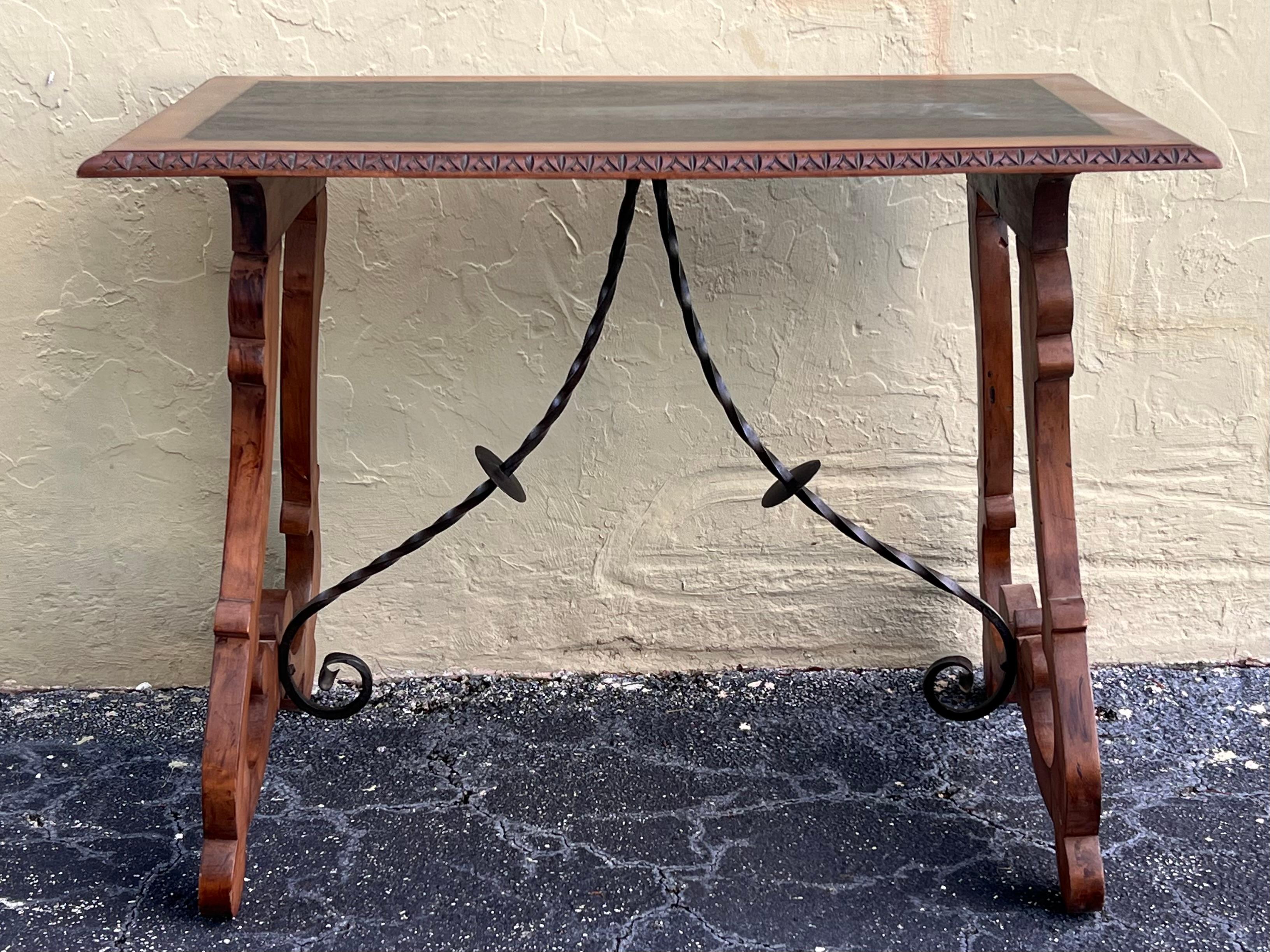 19th century Spanish trestle table in walnut. This piece has a great scale, lovely carved lyre legs and beautiful ebonized top. This table could be used as an end table, nightstand, side table or small desk.
Restored.