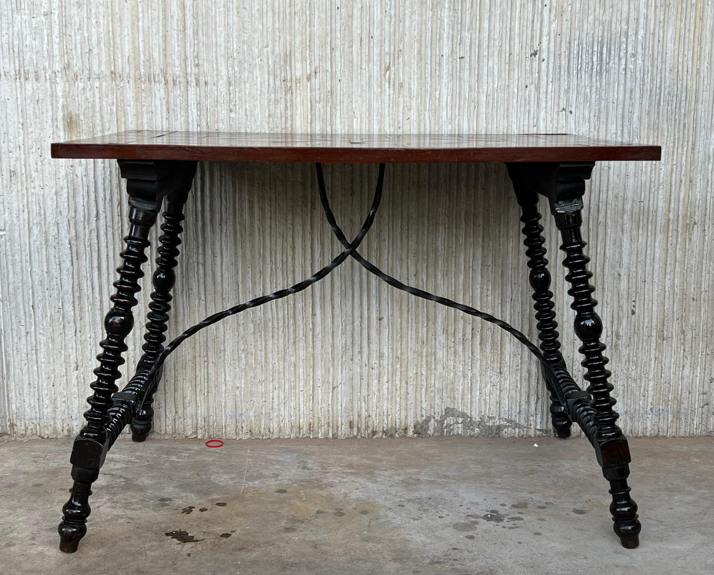 19th Century Baroque Spanish side table with marquetry top and iron stretcher

19th century Spanish trestle table in walnut. This piece has a great scale, lovely turned legs and beautiful marquetry top. This table could be used as an end table,