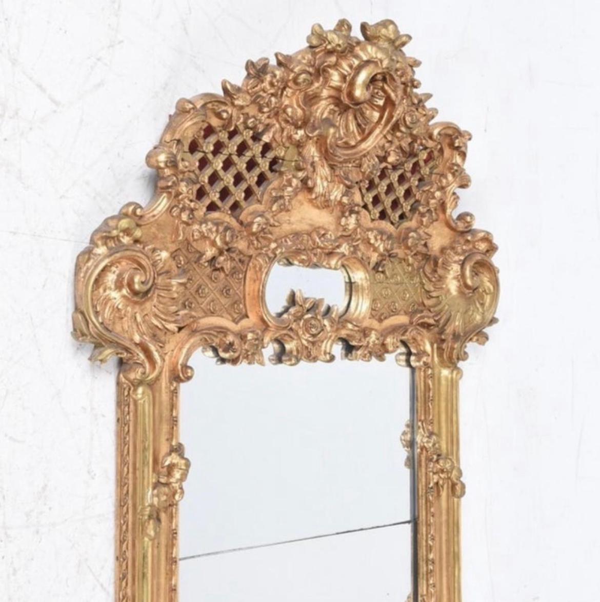 Here is a stunning and very rare Baroque Swedish giltwood mirror with split glass in great condition at a great price. This piece is truly special and is circa 1870-1879. Perfect for an entry way, above a commode, alone by itself in a hallway, etc.