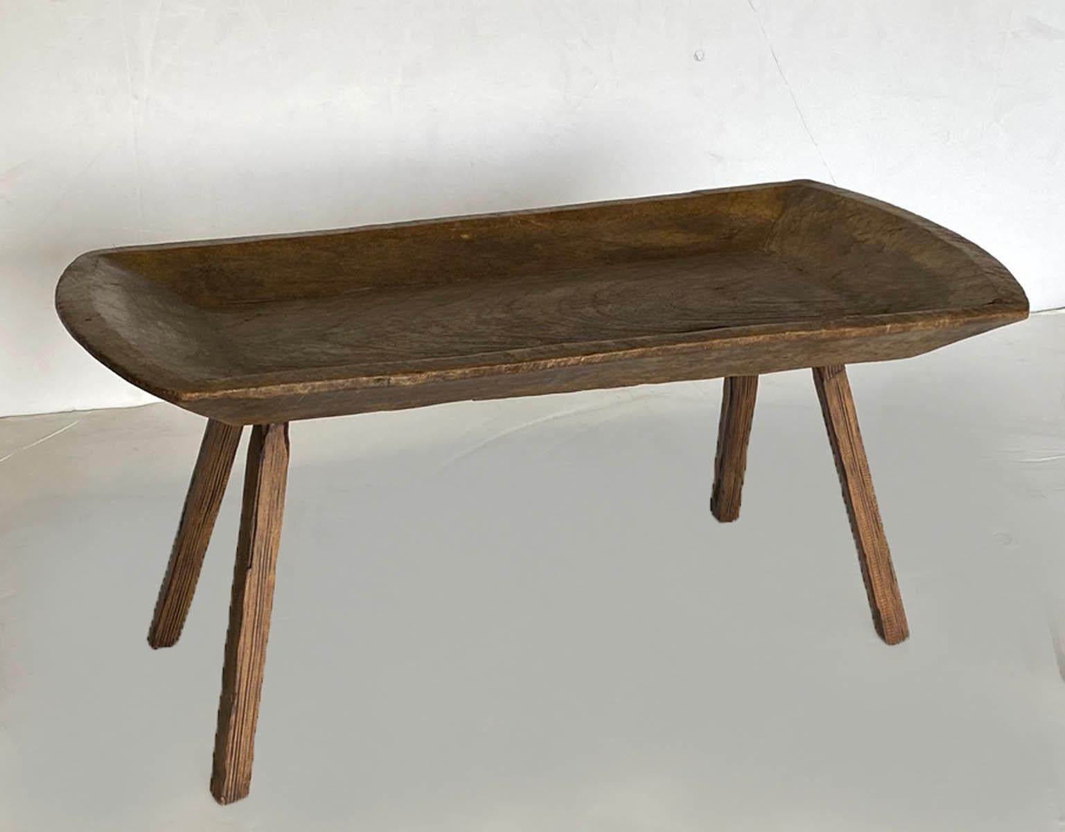 A side table made from an antique, 19th century wooden tray from Guatemala. Hand carved legs have been added and matched to top. Great little catch all side table or small coffee table. Beautiful patina.