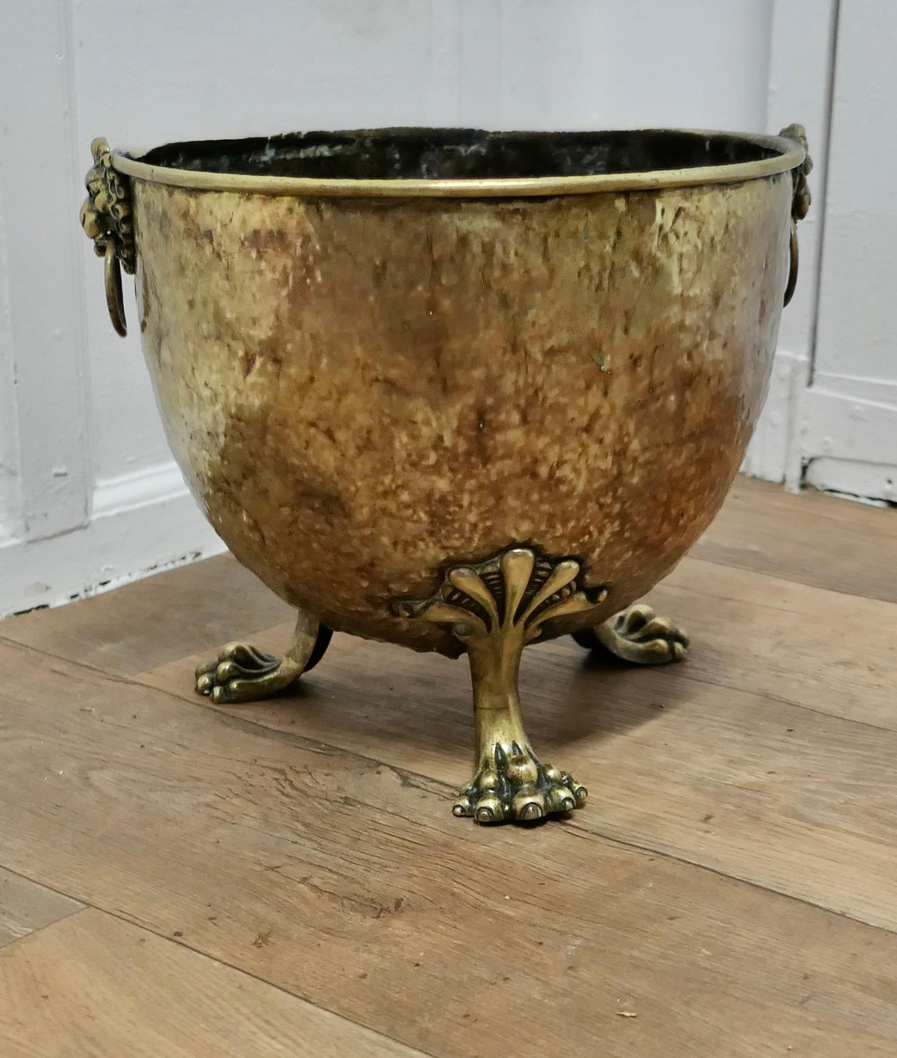 19th Century Beaten Brass Lions Mask Log Bin  

This is a good quality Brass log or coal bin, it has 2 Lions Mask handles and it is set on 4 chunky lions paw feet.
The Brass Cauldron would work well as a log basket or as a planter for a large