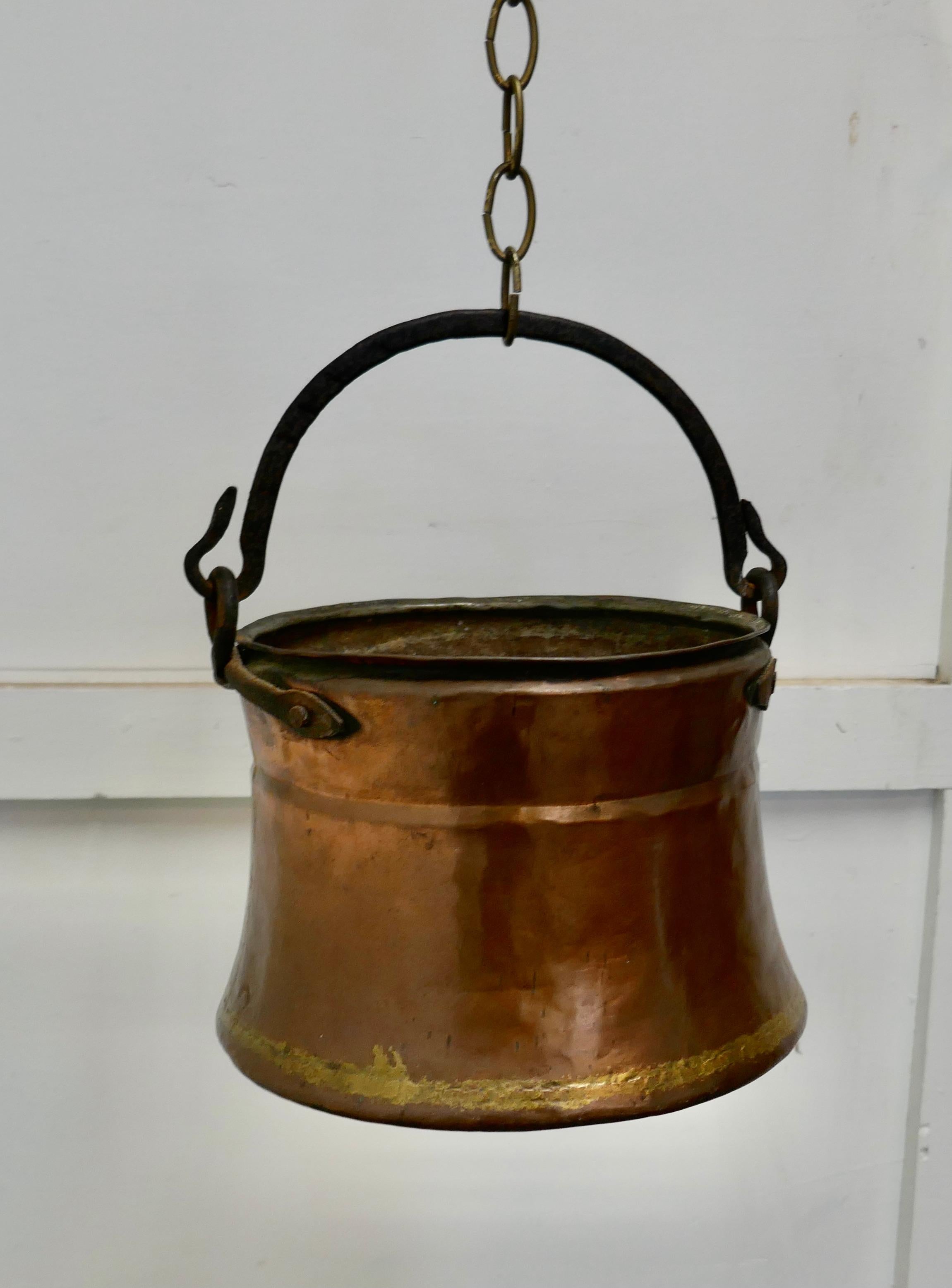 19th century beaten copper cooking pot, cauldron

This is a lovely early cooking pot, it is made in beaten copper, slightly flaring out at the bottom, to catch the maximum heat from the fire 
The pot has a rolled top, brass brazing and the Iron