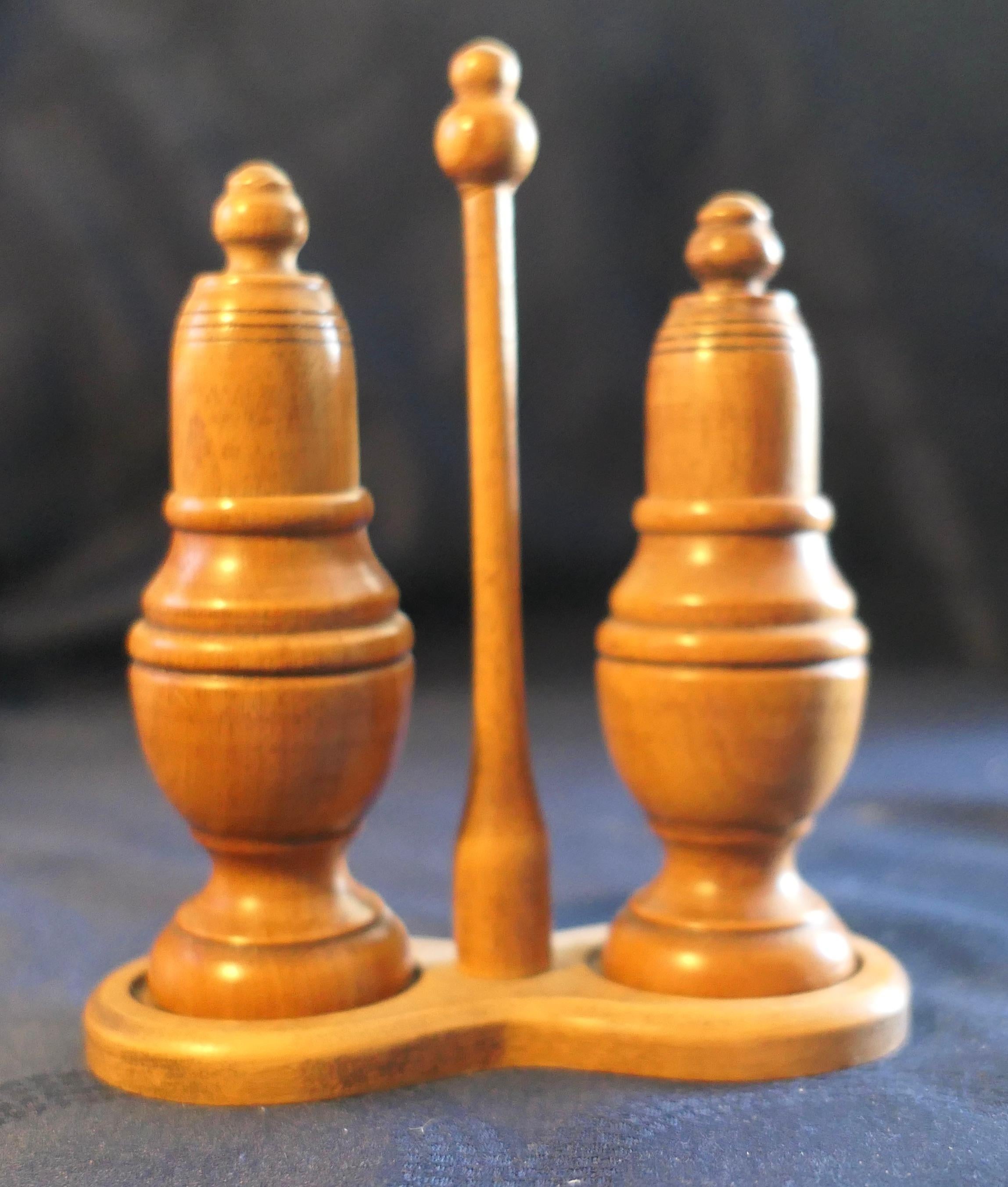 19th Century Beech Treen Salt and Pepper Shakers on Stand

This beautiful set has been hand turned on a lathe in the Georgian style, the shakers come into 2 parts so that they can be  filled  
The wood has a wonderful colour and patina
The set is in