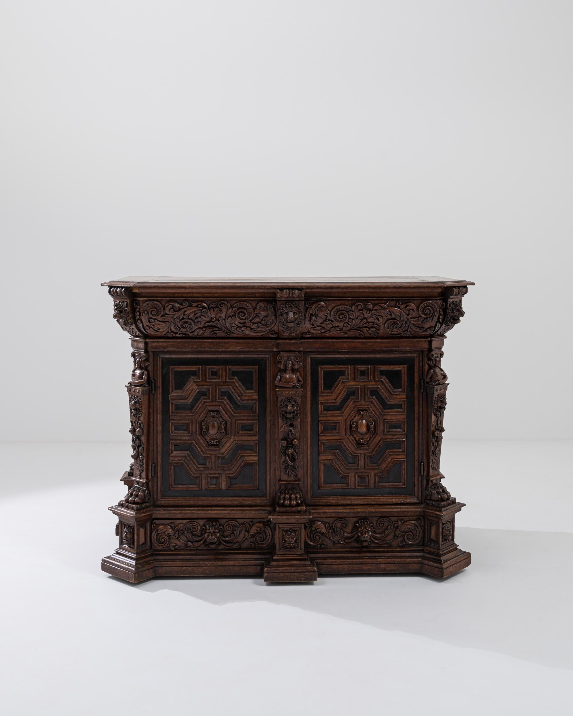 A wooden buffet from 19th century Belgium. Intricate floral patterning, figurative motifs, lion heads, and geometric mazes all are hand-carved into the front of this dazzling buffet. A feat of technical craftsmanship and vision, this remarkable