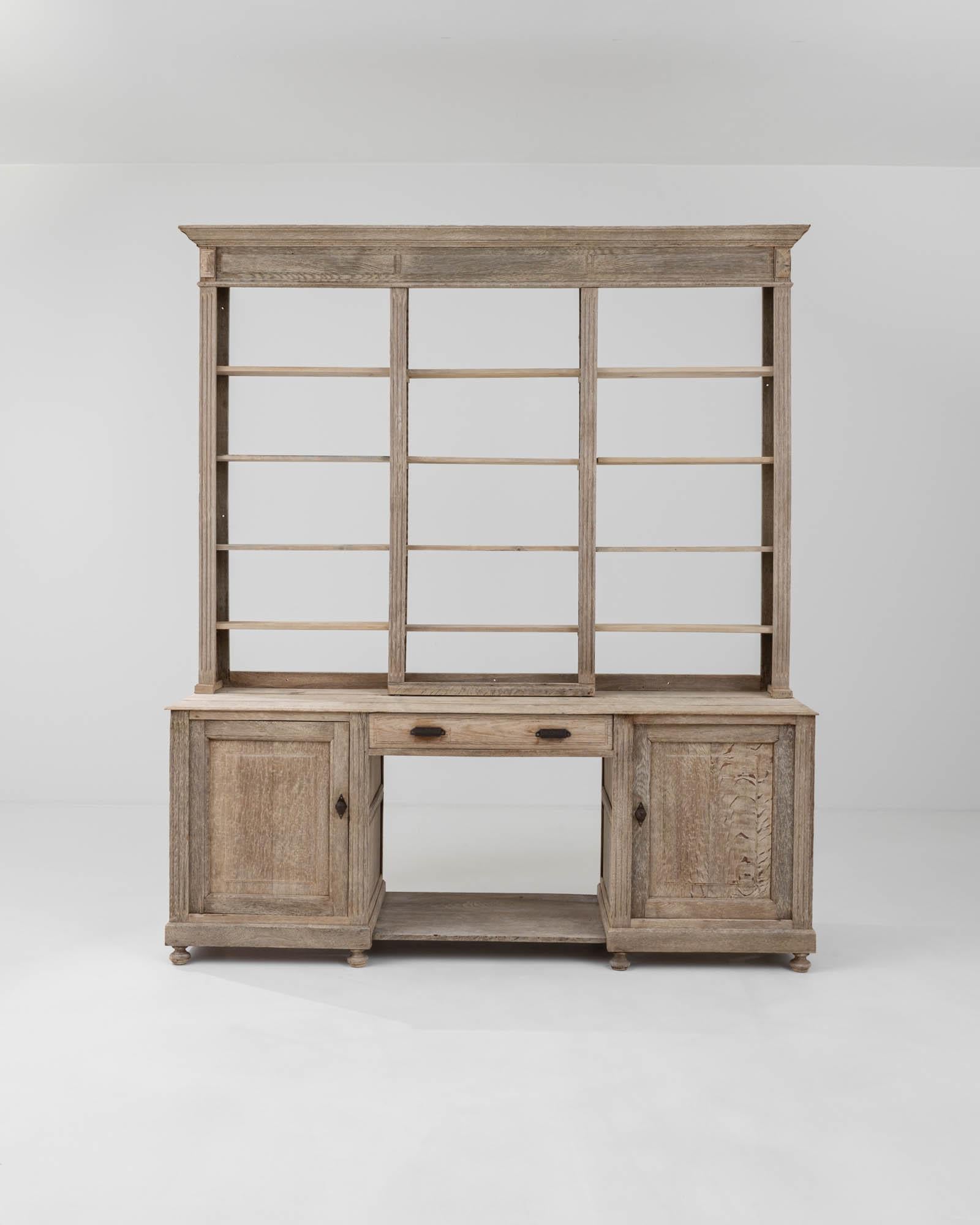 This unique étagère cabinet was handcrafted from quality European oak in Brussels, Belgium, as the metal plate indicates, during the 19th century.. The distinctive structure of this à deux corps chest is characterized by three sections, providing