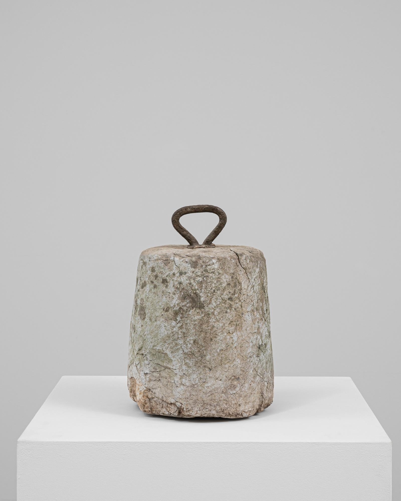 This 19th Century Belgian concrete door stop is a utilitarian object elevated by timeworn charm and material authenticity. Crafted from solid concrete with a naturally aged surface, it bears the marks of long-term use, including weathering, chips,