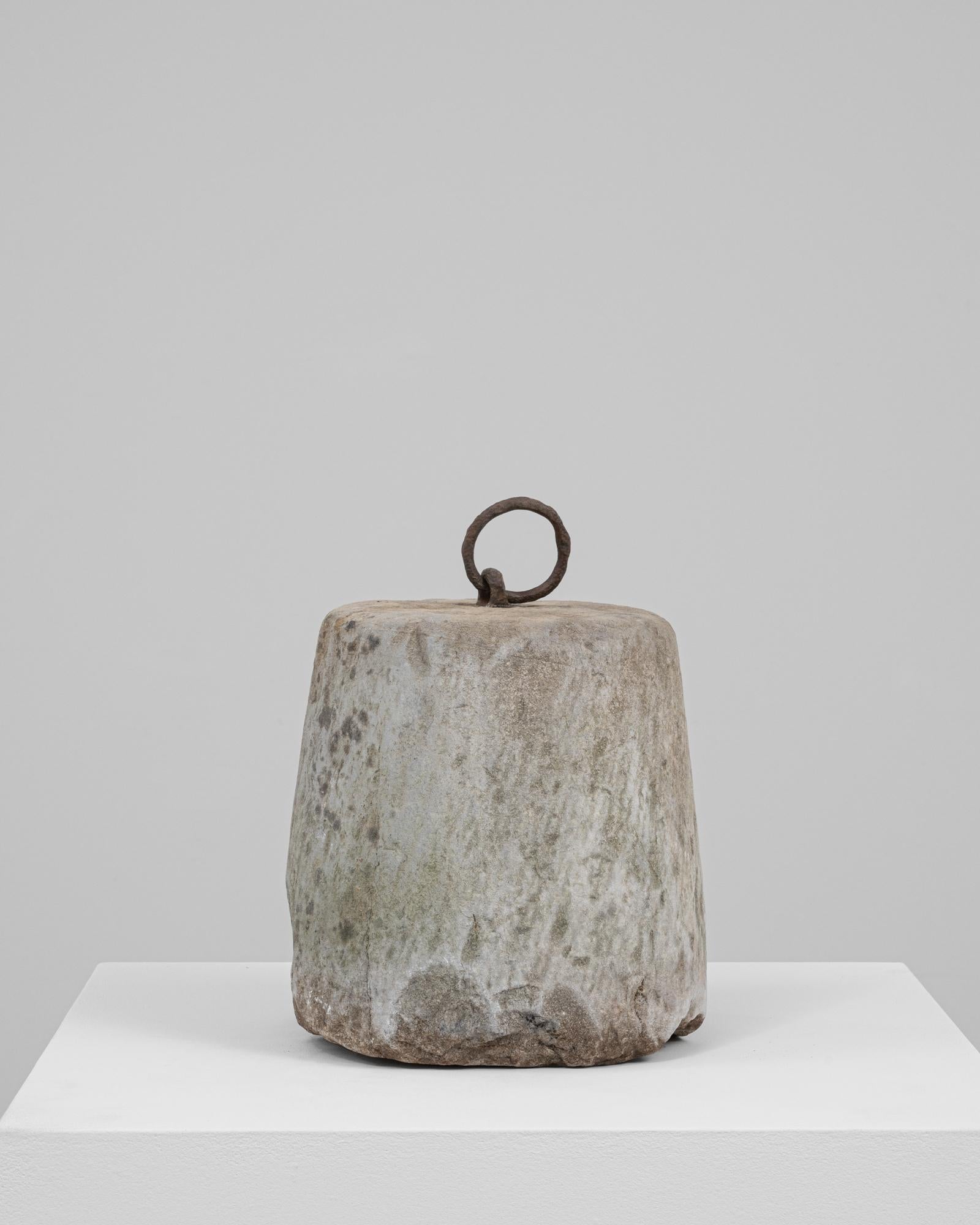 This 19th Century Belgian concrete door stop is a humble yet evocative artifact of utilitarian design. Cast in a tapered cylindrical form, its surface is richly weathered with natural patina, subtle discoloration, and age-softened edges that speak