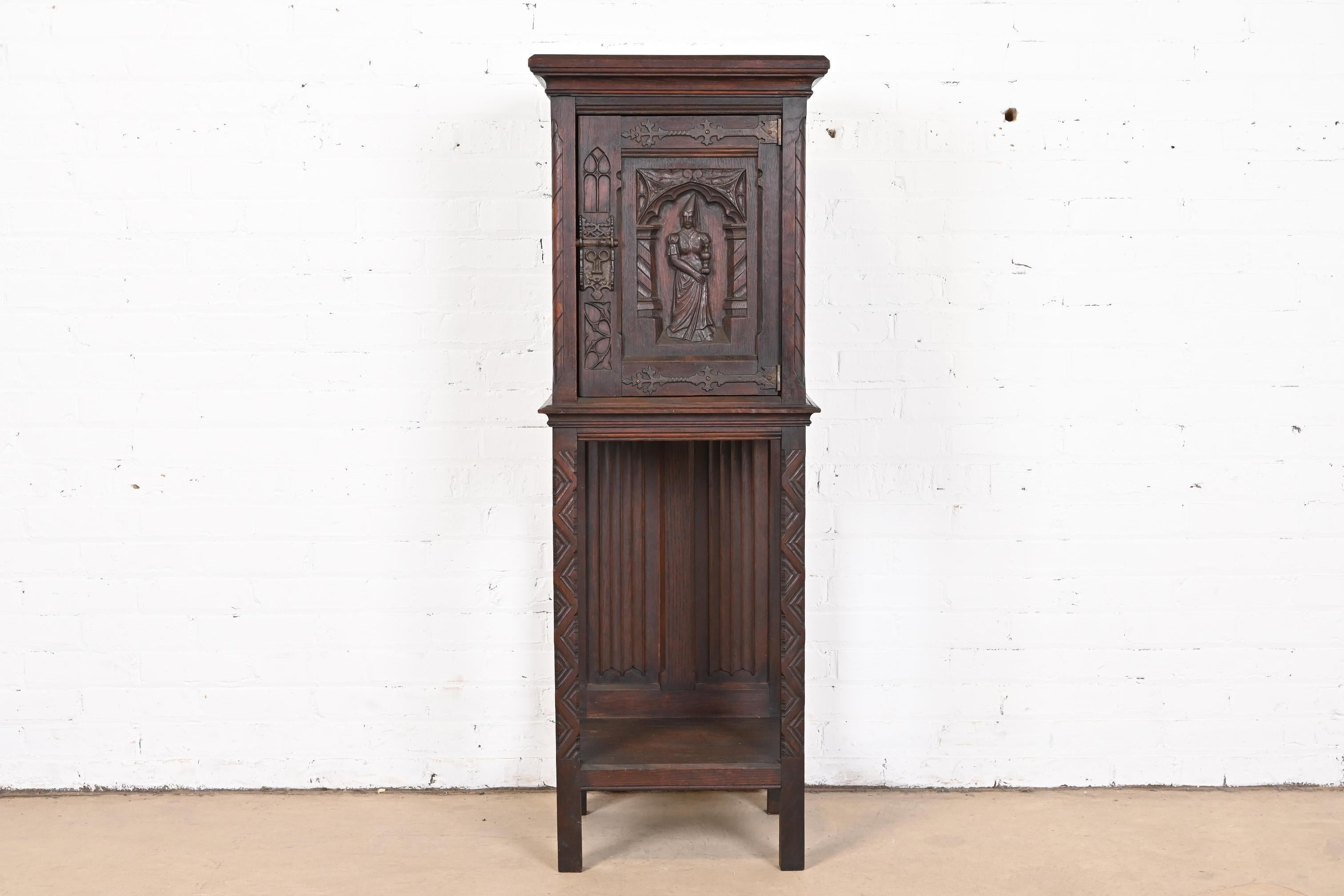 A gorgeous Gothic or Renaissance Revival bar cabinet

Belgium, Circa Late 19th Century

Carved dark oak, with original iron hardware.

Measures: 18.25