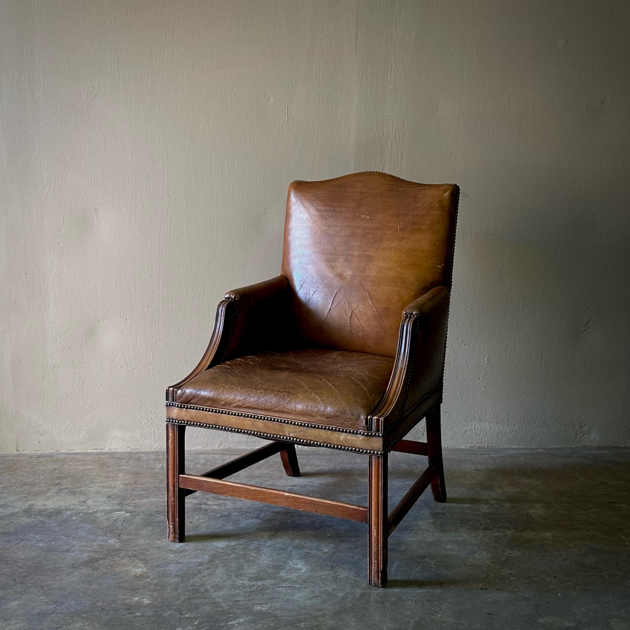 1860s Belgian wingback armchair with buttery chestnut leather upholstery and simple carved mahogany framework. Handsome and understated, this would work especially well as an office or desk chair. 

Belgium, circa 1860

Dimensions: 23.6 W x 25.6