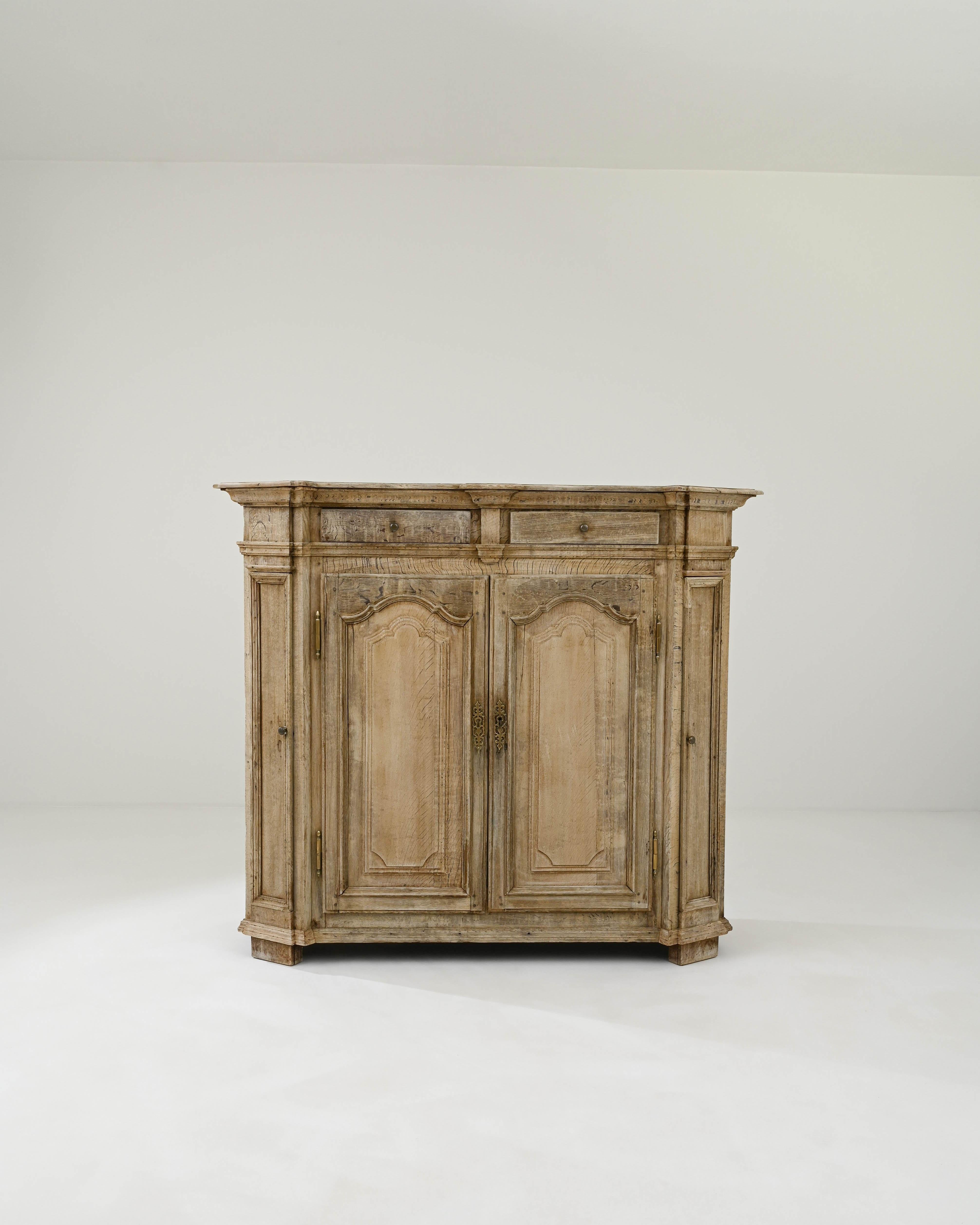 Timeless craftsmanship and the beautiful finish of the natural oak make this antique buffet a find to treasure. Hand-built in Belgium in the 1800s, discreet decorative accents bring personality to the spacious cabinet. The ogee peaks of the arched