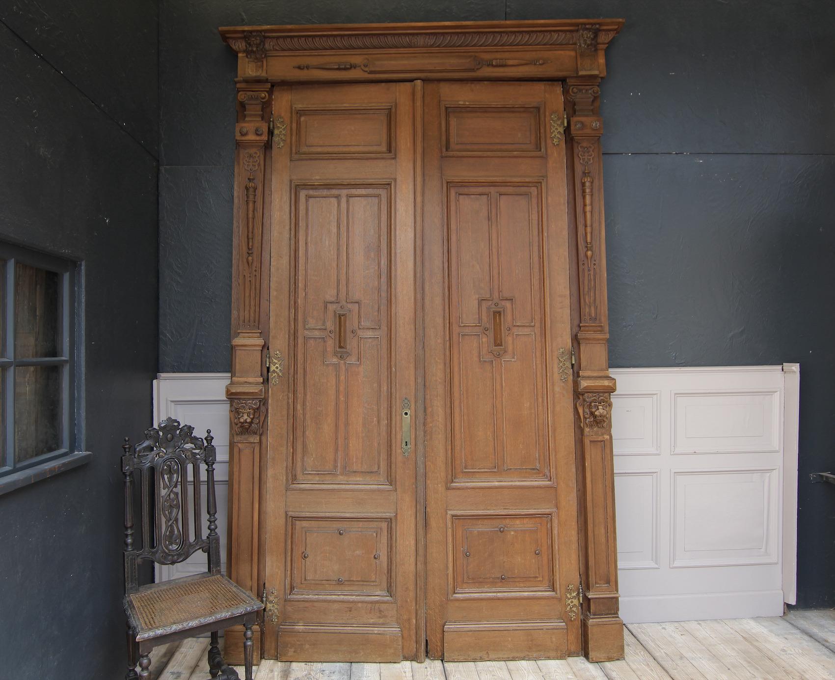 Large Belgian double door with frame from the 19th century. 

The front side shows the oak which it is made of, the back of the door is in beautiful original paint.

The doors each have 3 cassettes. There is the original frame included for the