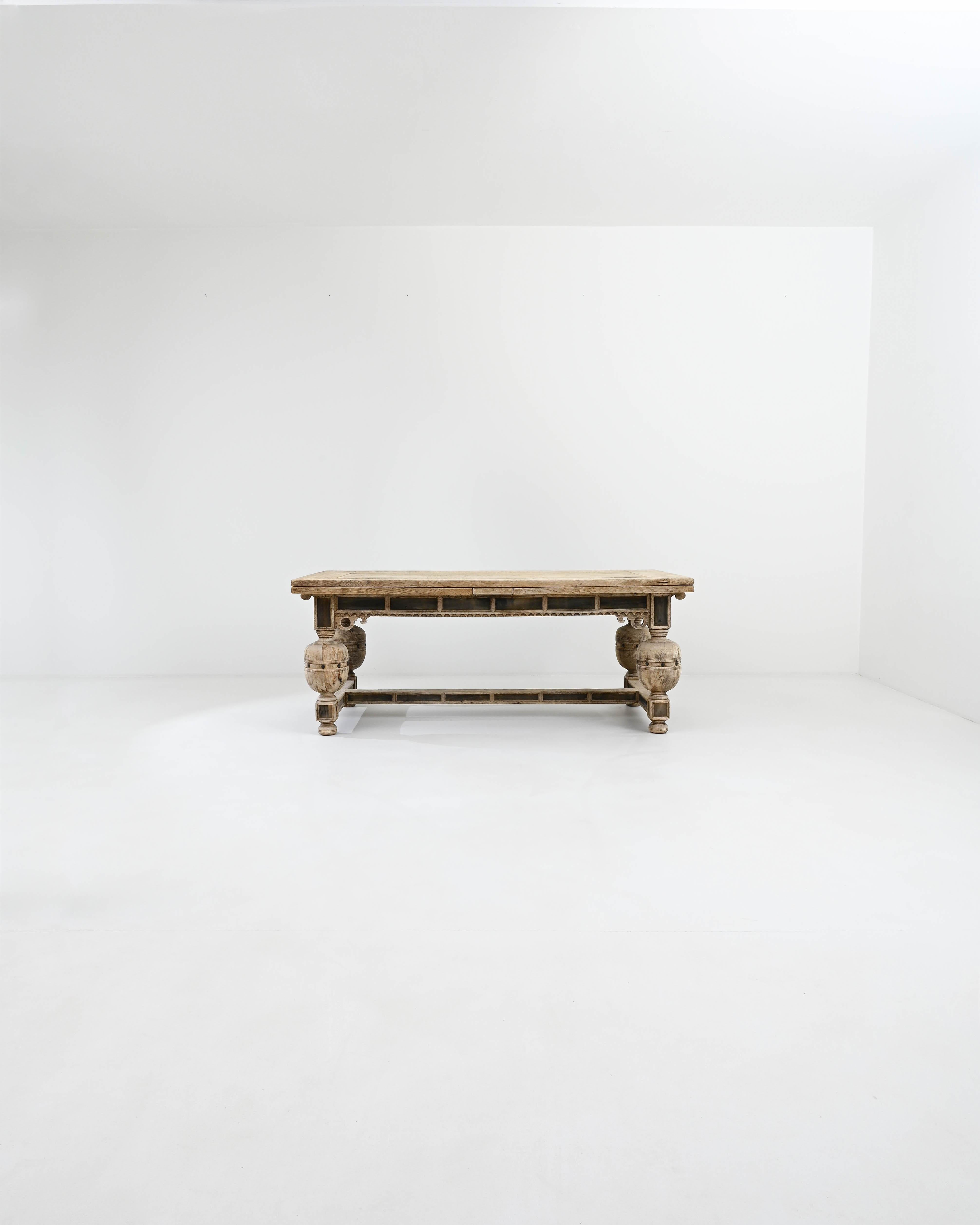 Striking and majestic, this antique oak dining table makes a one-of-a-kind centerpiece. Built in Belgium in the 1800s, the design takes inspiration from the solid, ornate furniture of Renaissance palaces and villas. Decorative brackets and