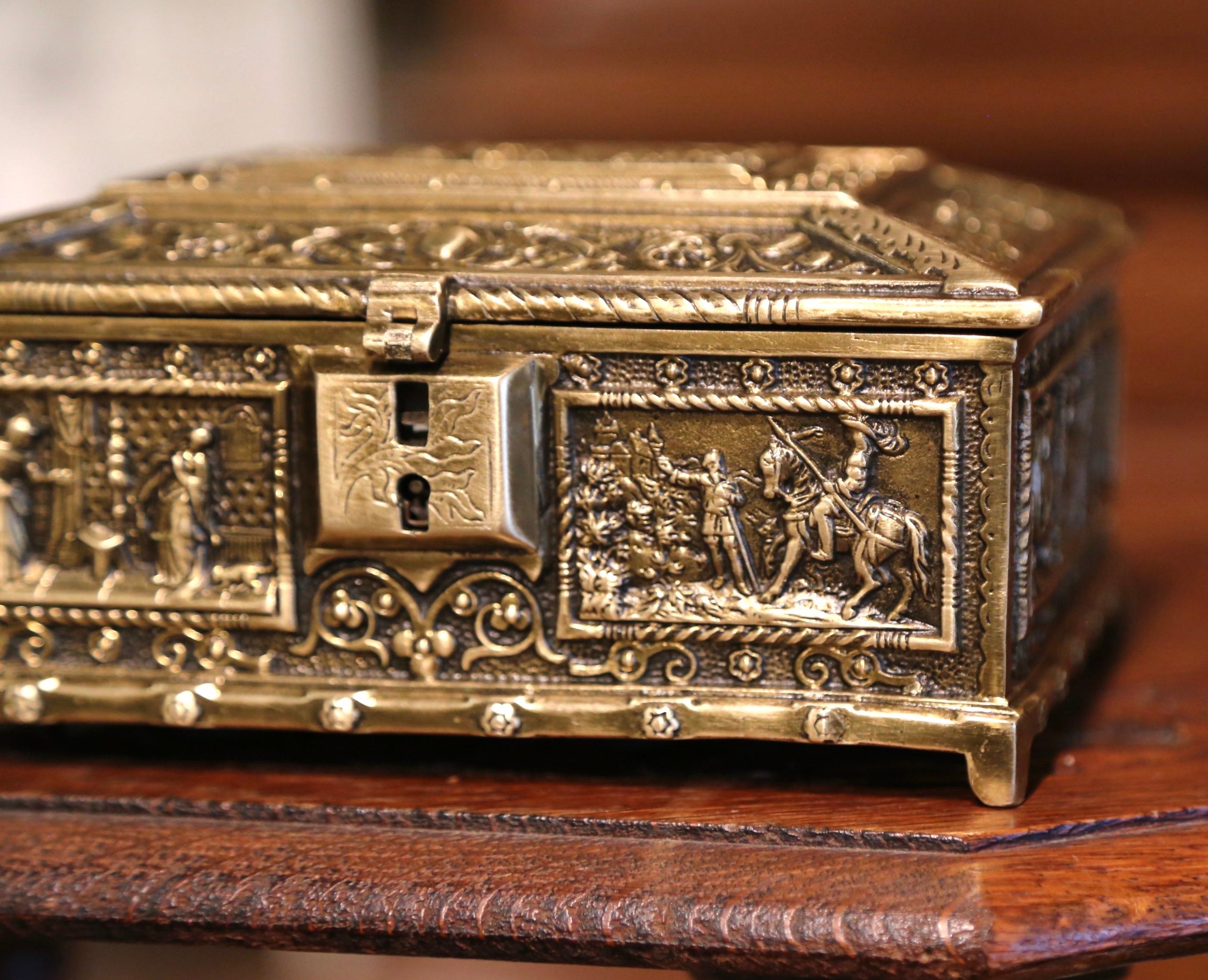 This antique Renaissance casket was created in Belgium, circa 1880. Rectangular in shape, the gilt bronze box is embellished with French court motifs, including a courting scene on the top. The sides depicts scenes like a duke riding his horse, a