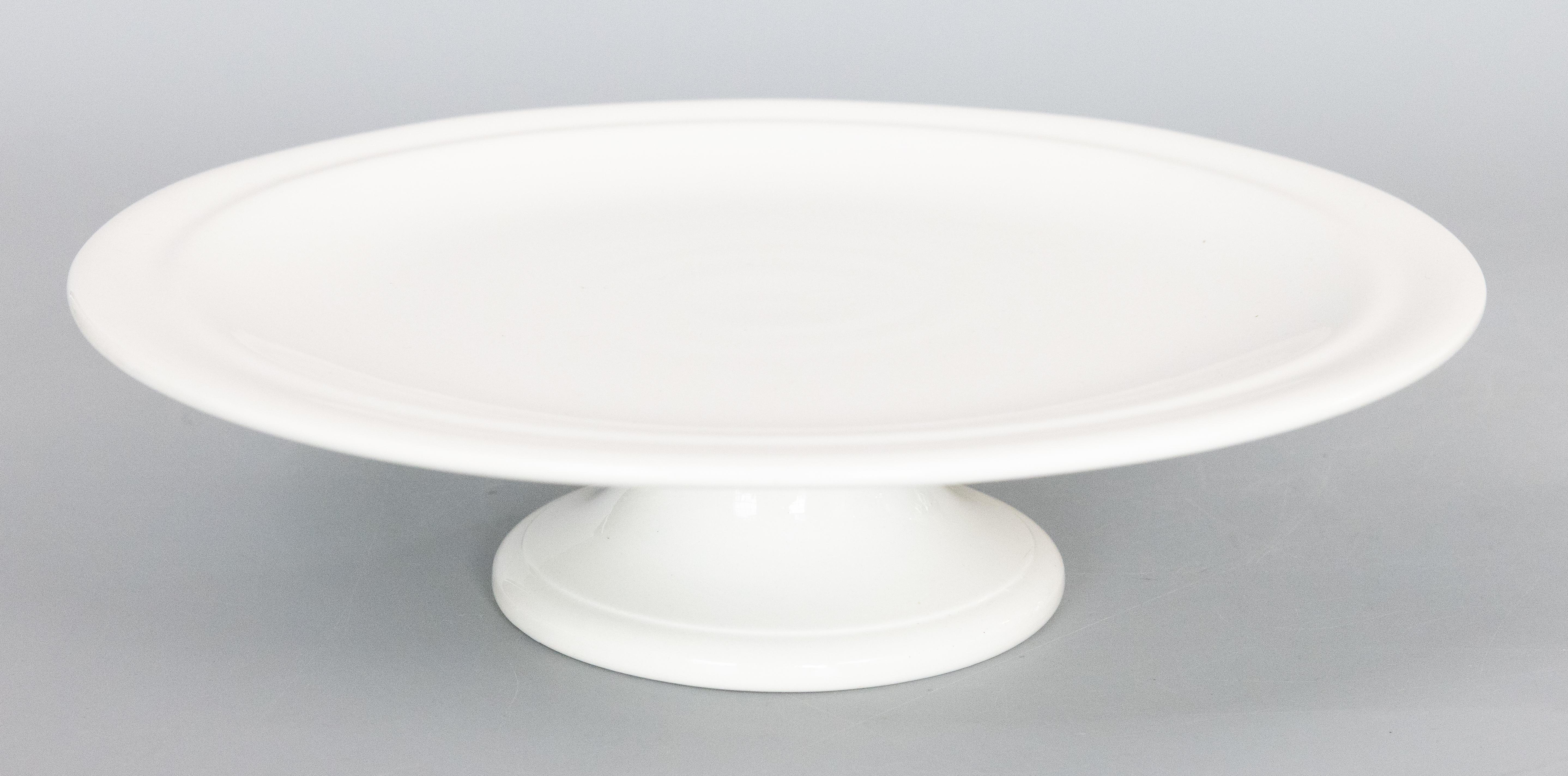 A gorgeous antique white ironstone cake stand on a pedestal made by NIMY Imperiale Royale from Belgium, circa 1890. Maker's mark on reverse. A highly collectible ironstone piece in beautiful antique condition. This gorgeous cake stand will elevate