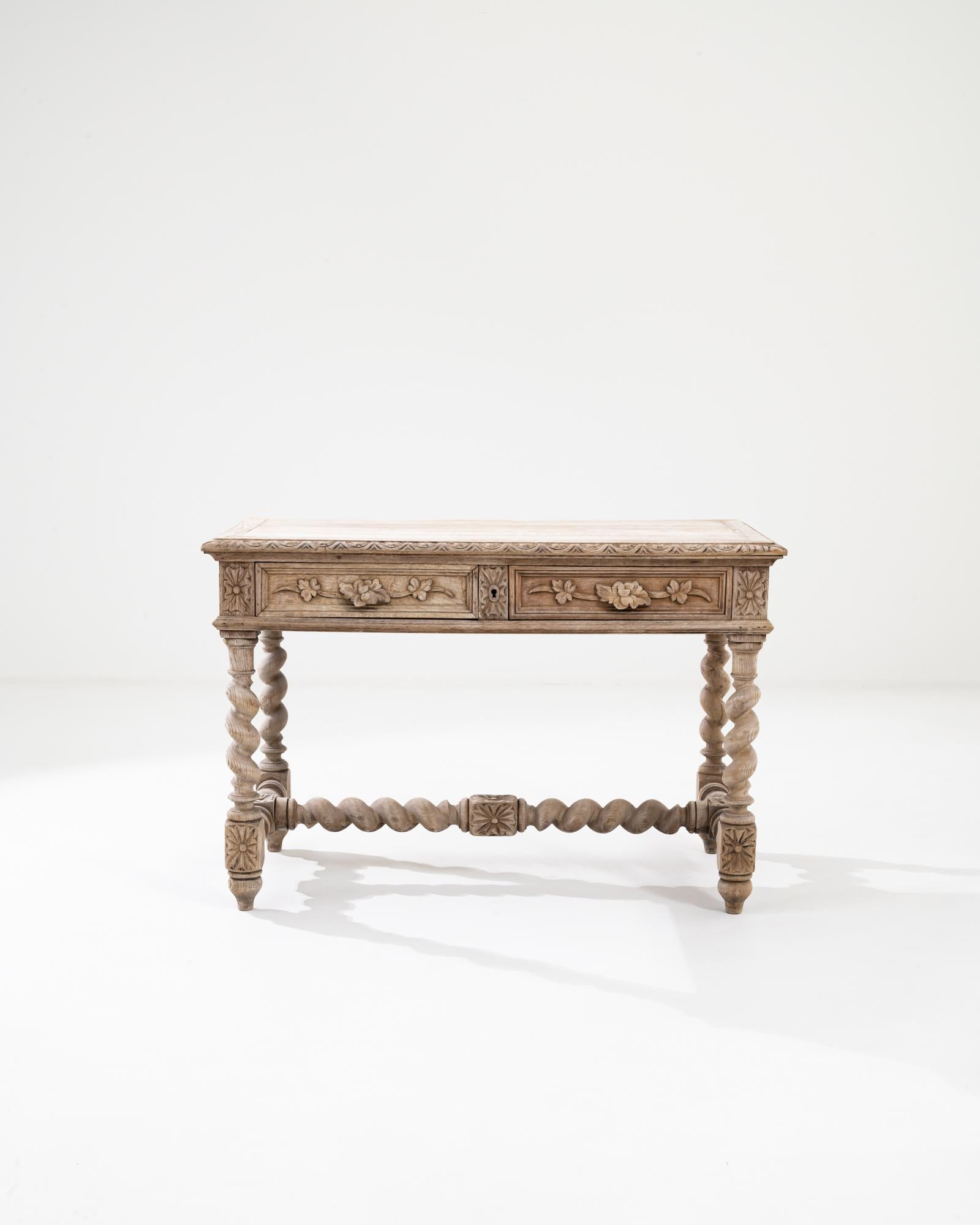A wooden side table from 19th century Belgium, made in the Flemish style. Fit with spiraling legs and lavishly carved details, this side table is brimming with unique character. The floral patterning inscribed along its aprons has been exquisitely