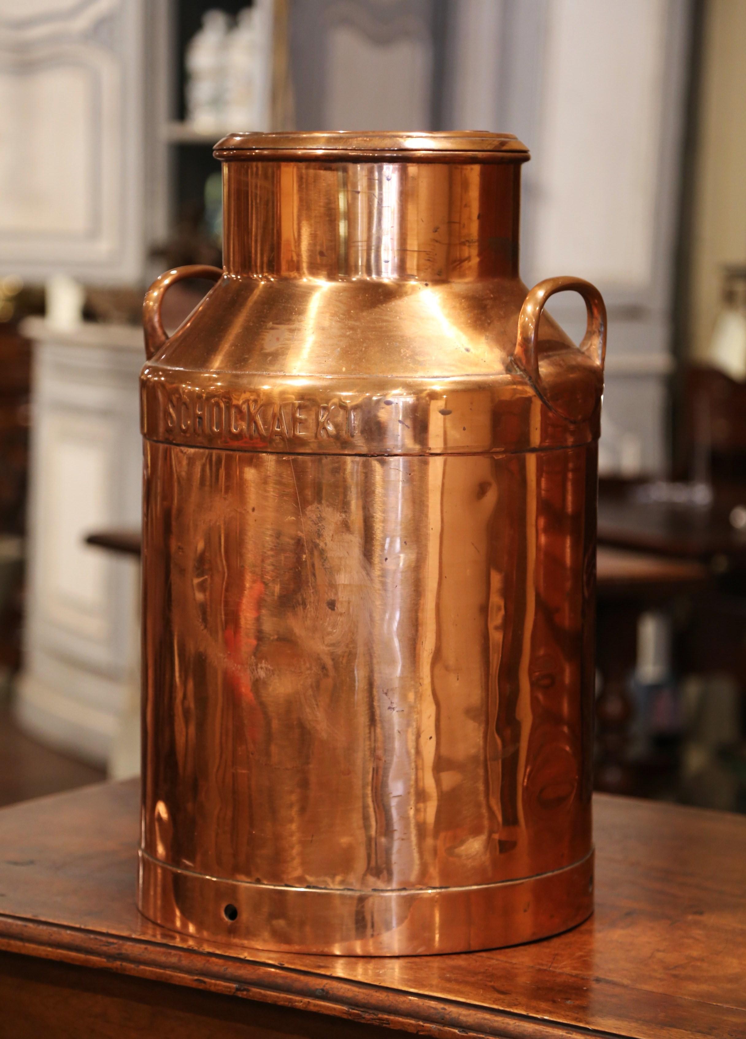 Use this beautiful antique milk can as an umbrella stand by your front door. Crafted in Belgium circa 1880, the tall metal and copper container has side handles and its original removable lid. The traditional, utilitarian piece is branded with the
