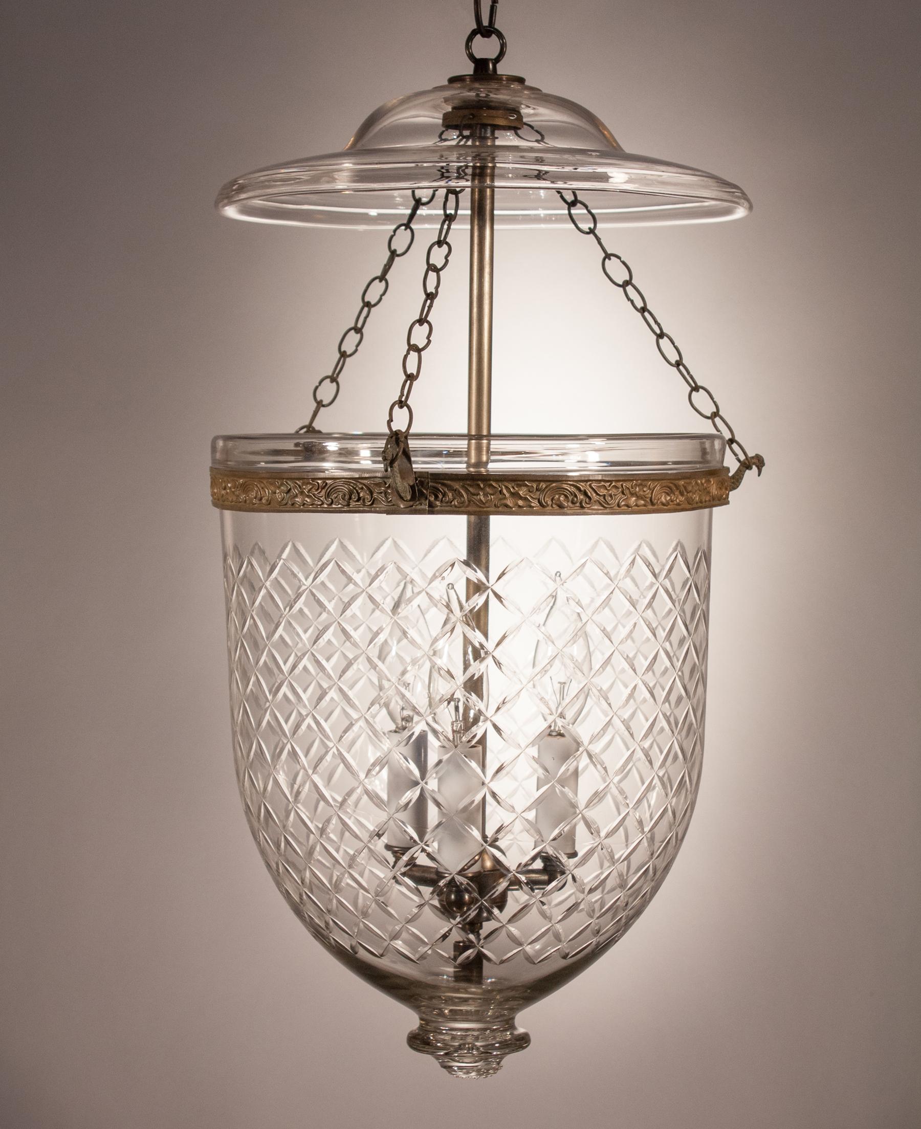 A circa 1870 bell jar lantern featuring excellent quality handblown glass and an etched diamond motif that complements the form of the lantern. This pendant light has retained all of its original fittings, including embossed brass band, chains, and