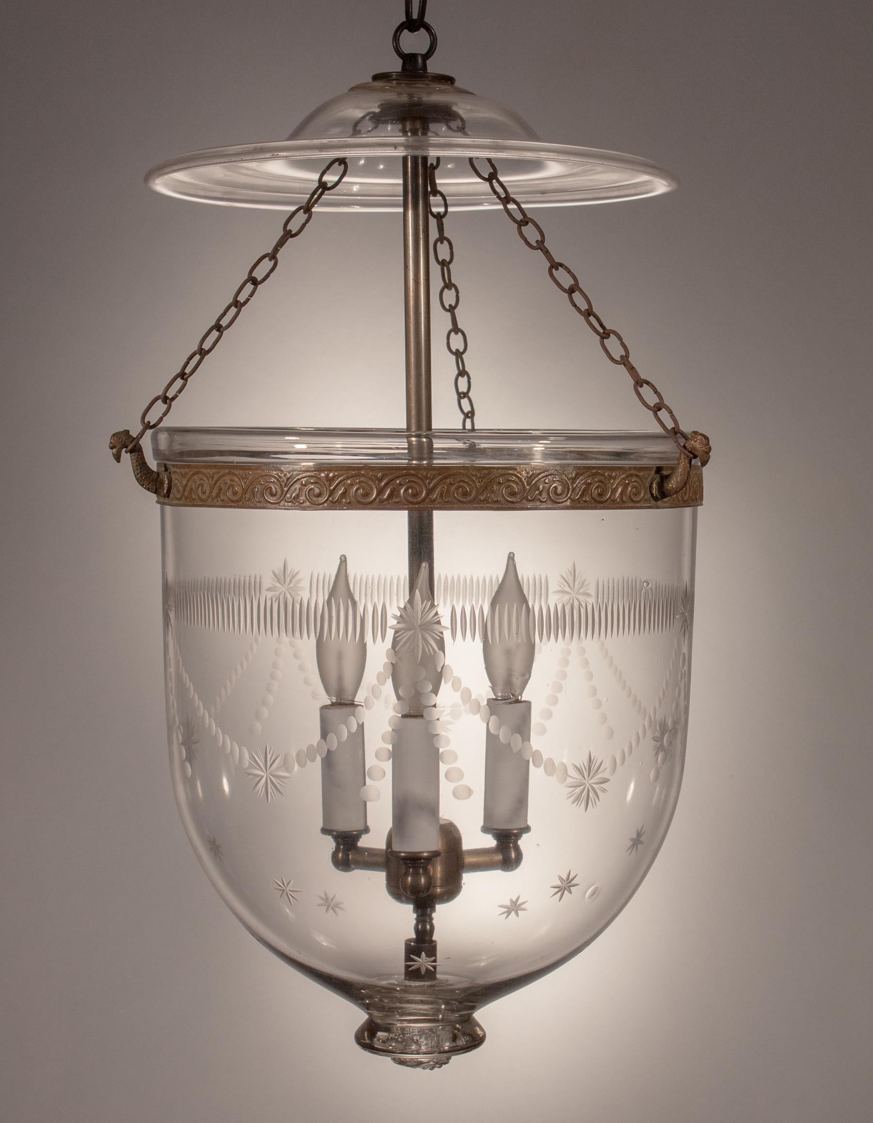 The quality of the handblown glass in this circa 1880 hall lantern is excellent. The bell jar has shapely form and the etched Federal style motif is a lovely complement. The brass band, which was replaced at some point in the lantern's journey, has