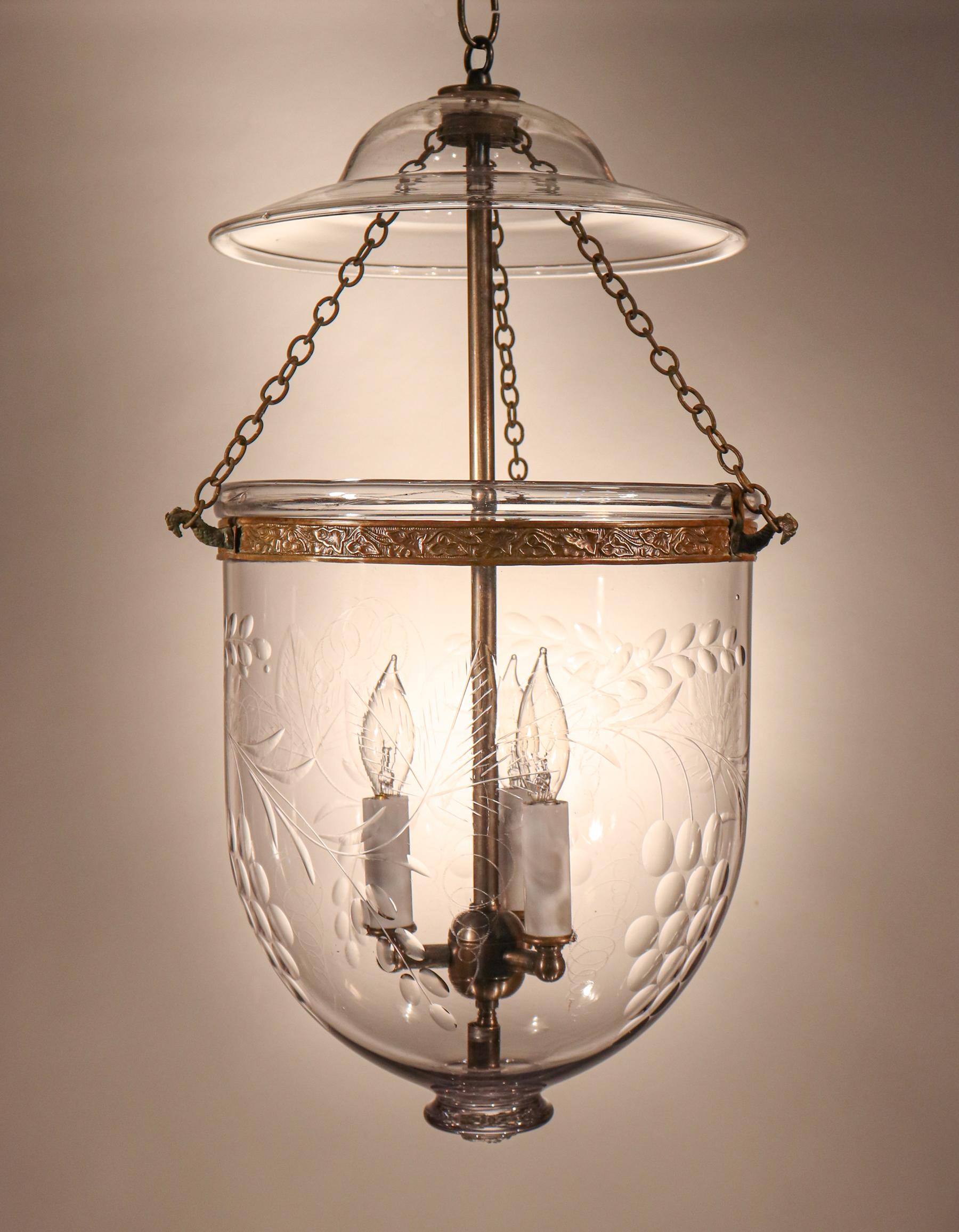 A beautiful antique bell jar lantern from England, circa 1880, with superb quality hand blown glass and an etched and polished grape and leaf design. The pendant light has all of its original fittings with the exception of the brass band, which has
