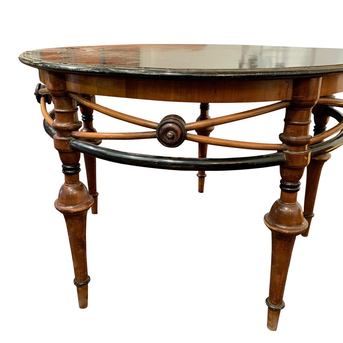 Late 19th century French Belle Époque round center hall table
Decorative criss cross wood details around the apron of the table
Contrasting brown and black typifies this style of furniture during this period
Bottom of the table recently