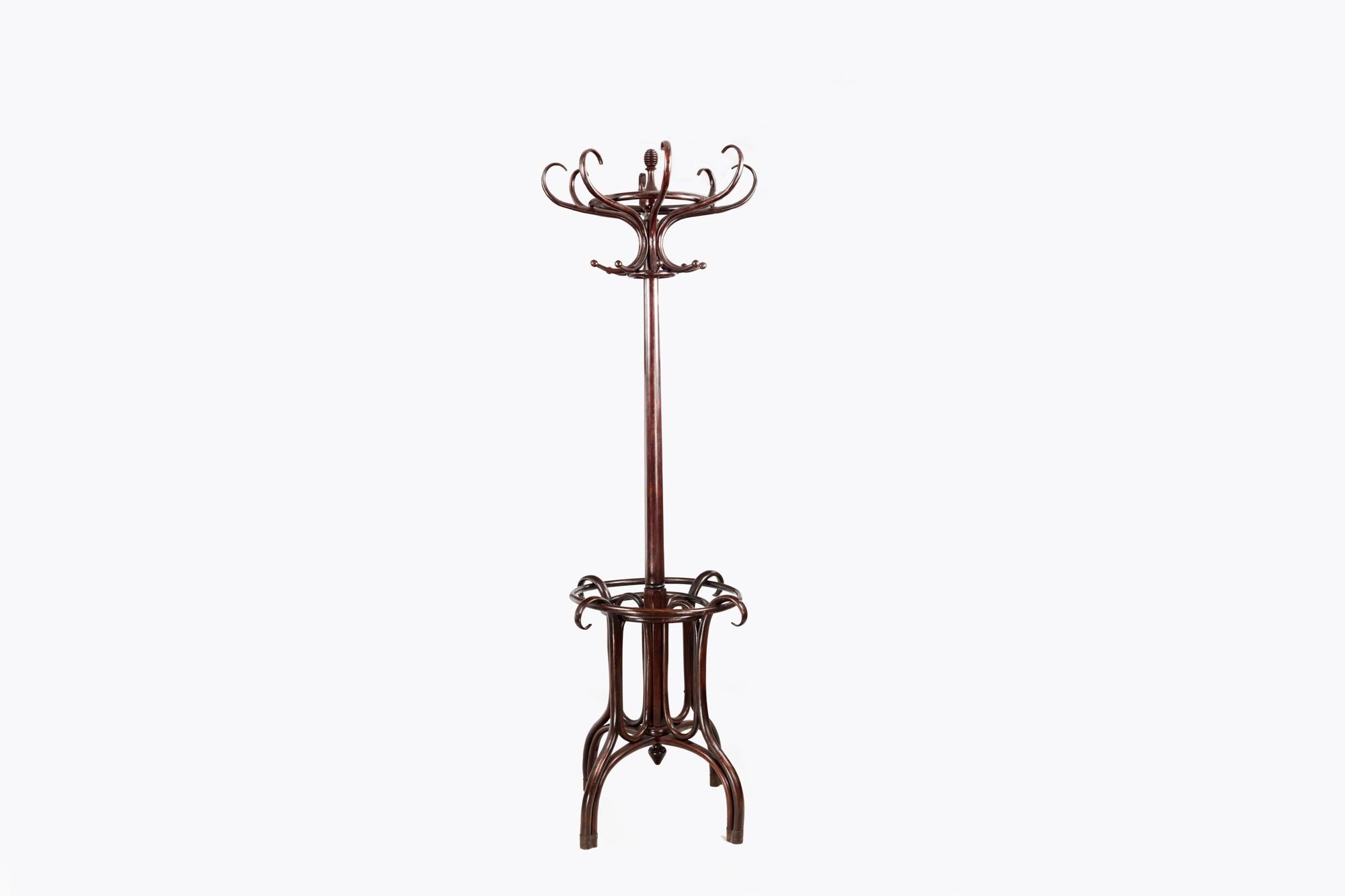 19th Century Bentwood hat and coat stand complete with unusual incorporated umbrella rack terminating on four swept bentwood legs and finished by a matching return finial on the base of the column. The upper crown of 8 double ended hooks for hats