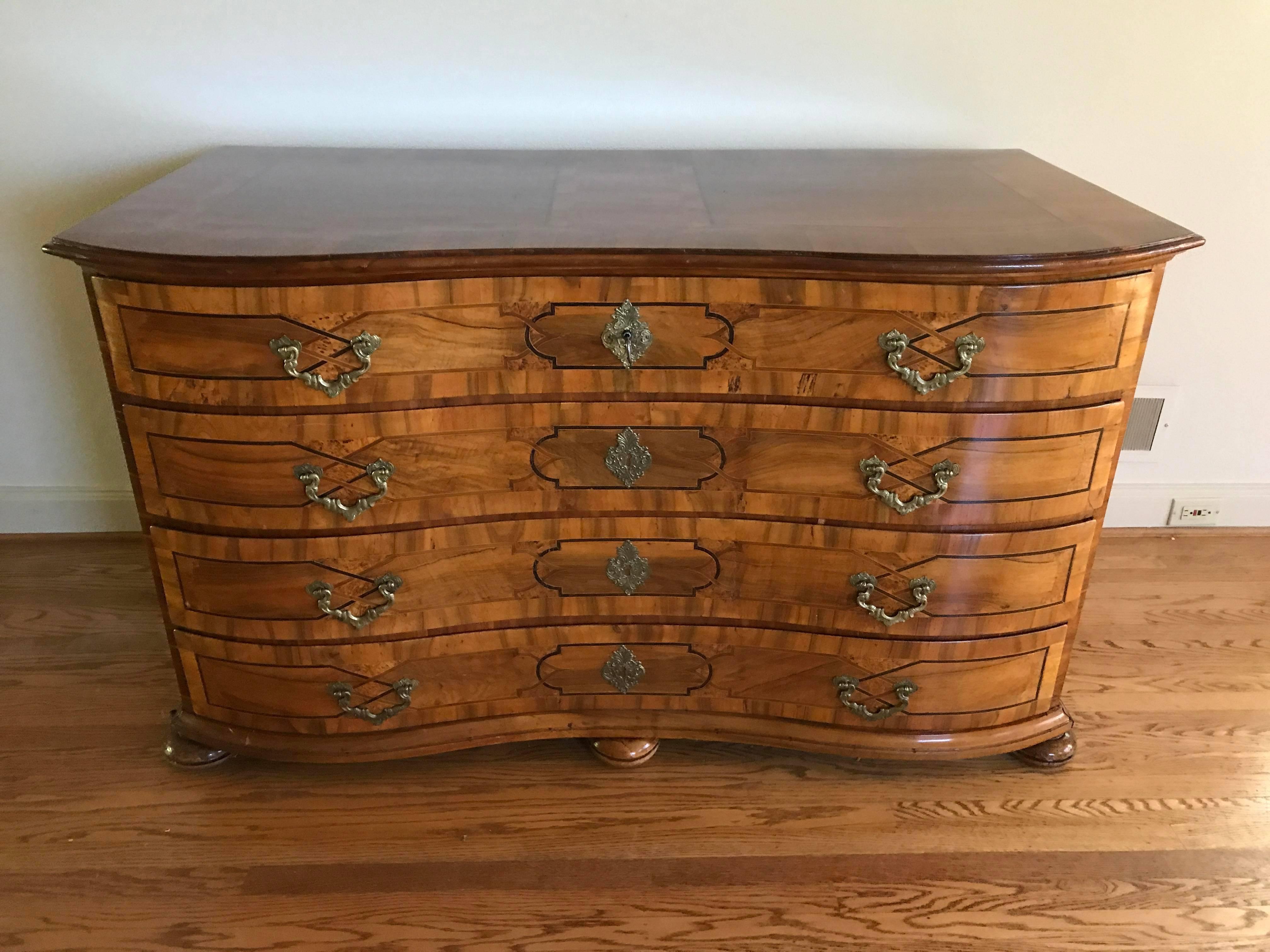 Serpentine front, four full width drawers, top locks with key, German ,circa 1850. Biedermeier design was derivative
of French Empire style furniture with an emphasis on clean lines and minimal ornamentation. This grew out of a basis in utilitarian