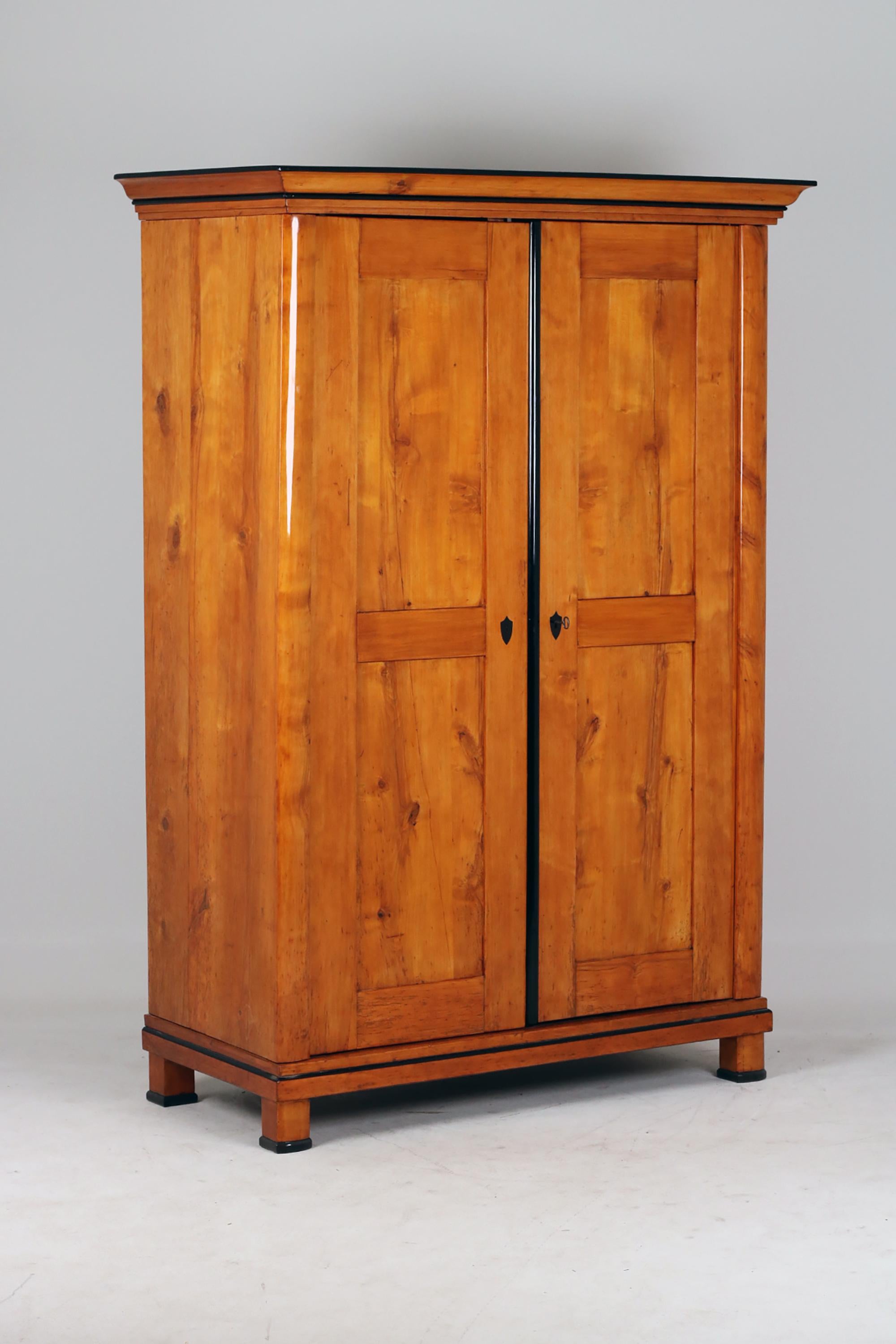 19th Century Biedermeier Cabinet,
Austria, 1830
Birchwood,

Biedermeier two door cabinet standing on four block feet with harmonious birch wood grain.
An example of piece of furniture from Austria. Pilasters strips are typical by furniture of this