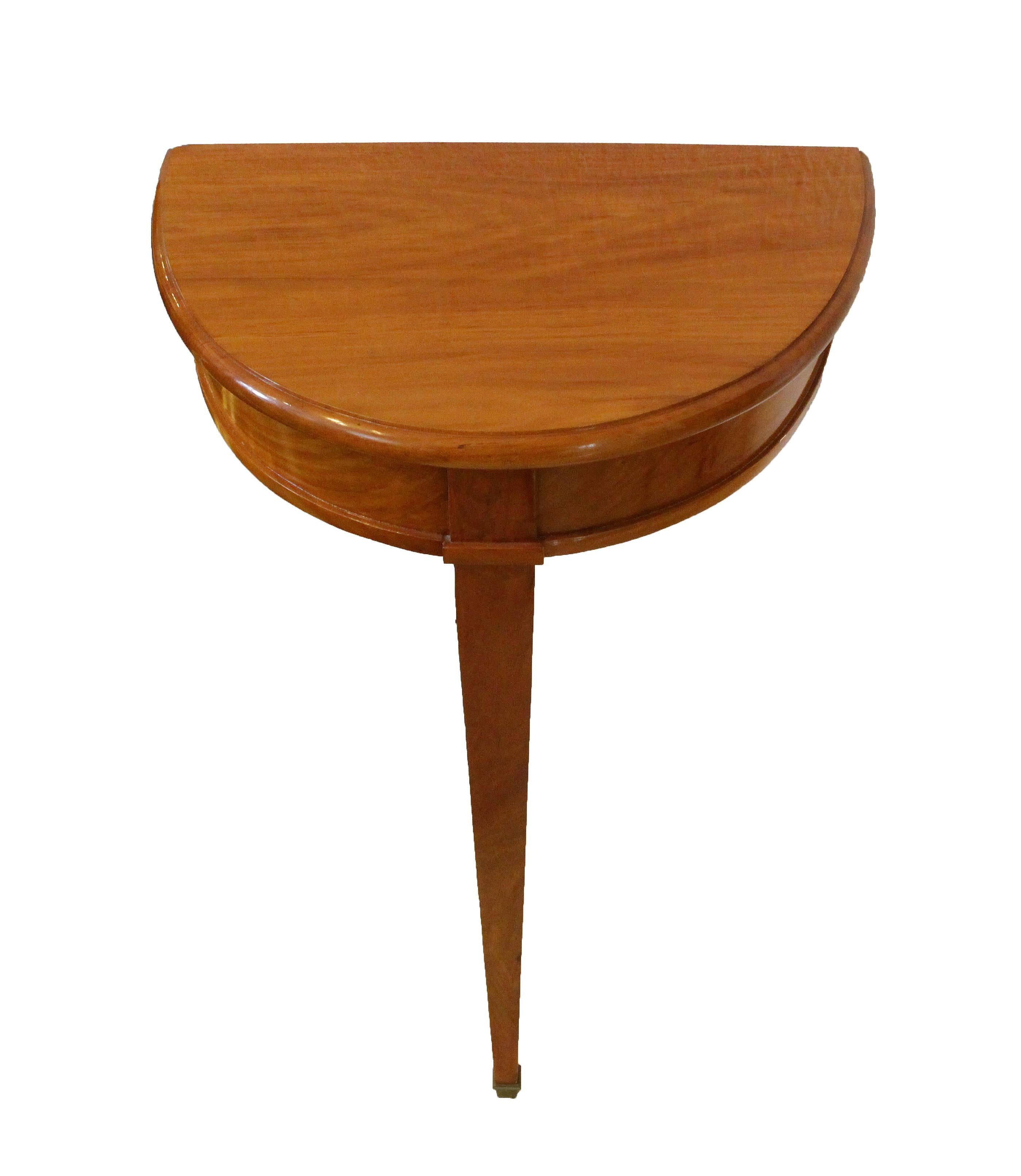 Small Cherrywood half side table from the time of Biedermeier with one leg. At the foot with brass shoe. The small table can be fixed to the wall.