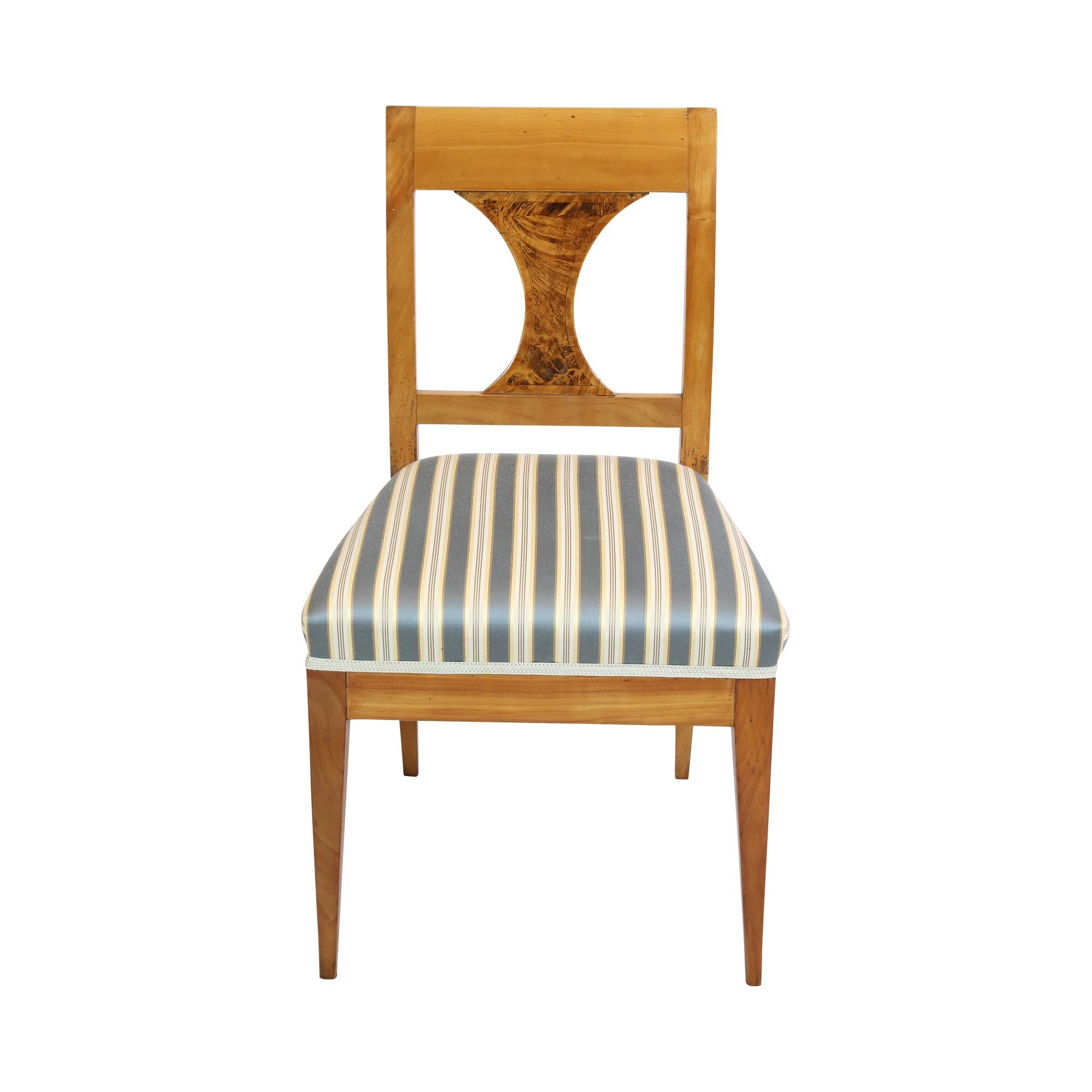 A chair from the Biedermeier period, ca. 1825. The chair is made of solid cherry wood. The chair is reupholstered and covered with new Biedermeier fabric. The center of the backrest is refined with birch wood. In very good restored condition.