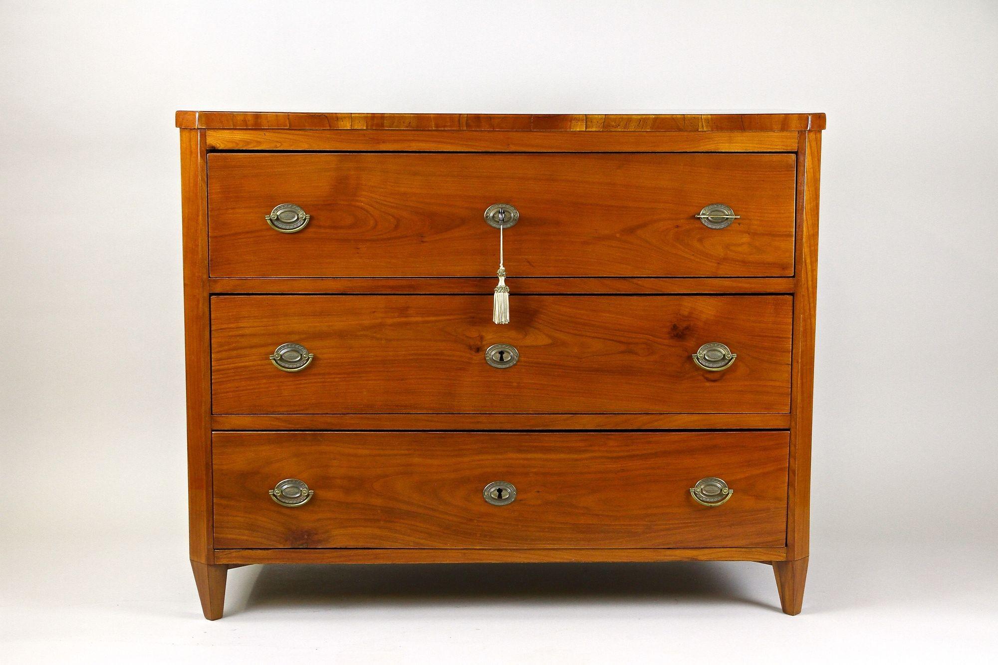 Fantastic looking 19th century cherrywood chest of drawers from the early Biedermeier period around 1830 in Austria. This newly restored antique three drawer Biedermeier commode impresses with its straight shaped lines and a beautiful cherrywood
