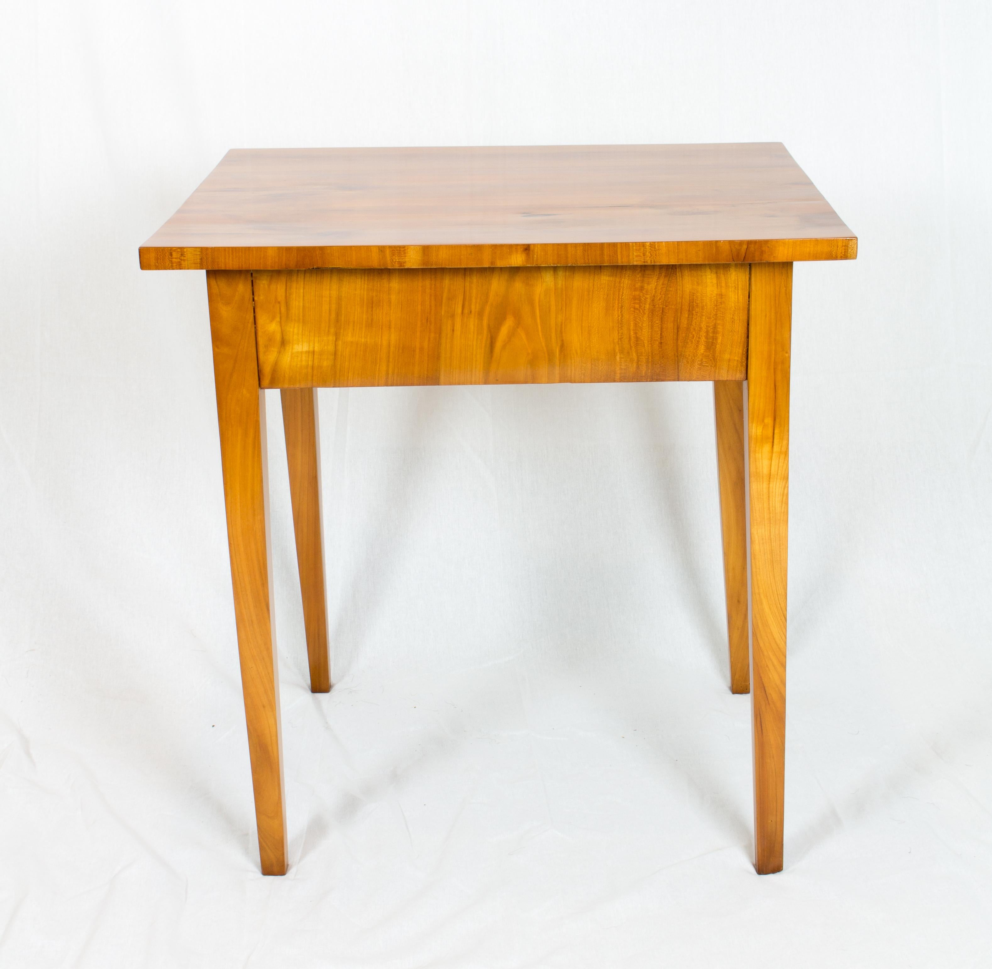 The side table is made of cherrywood veneer on a pinewood body, the table legs are solid cherrywood. A wonderful timeless design, dates back to the time of Biedermeier, circa 1820. The drawer is, as usual, made of pine wood, the panel of cherry. In