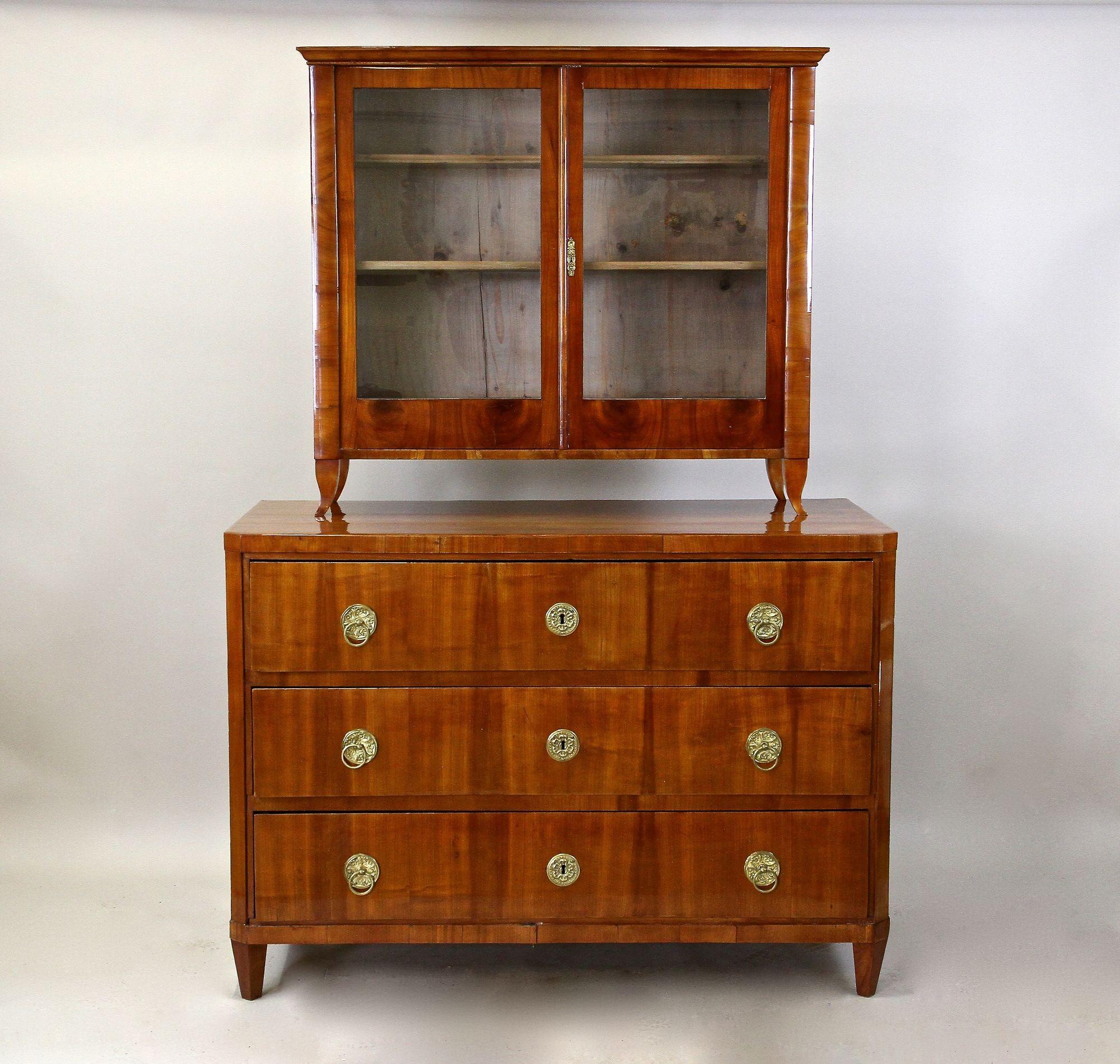Lovely, old restored 19th century Biedermeier chest of drawers or buffet from the early period around 1830 in Austria. This beautiful three drawer commode impresses with its thick cherrywood veneered surface showing a gorgeous looking grain flowing