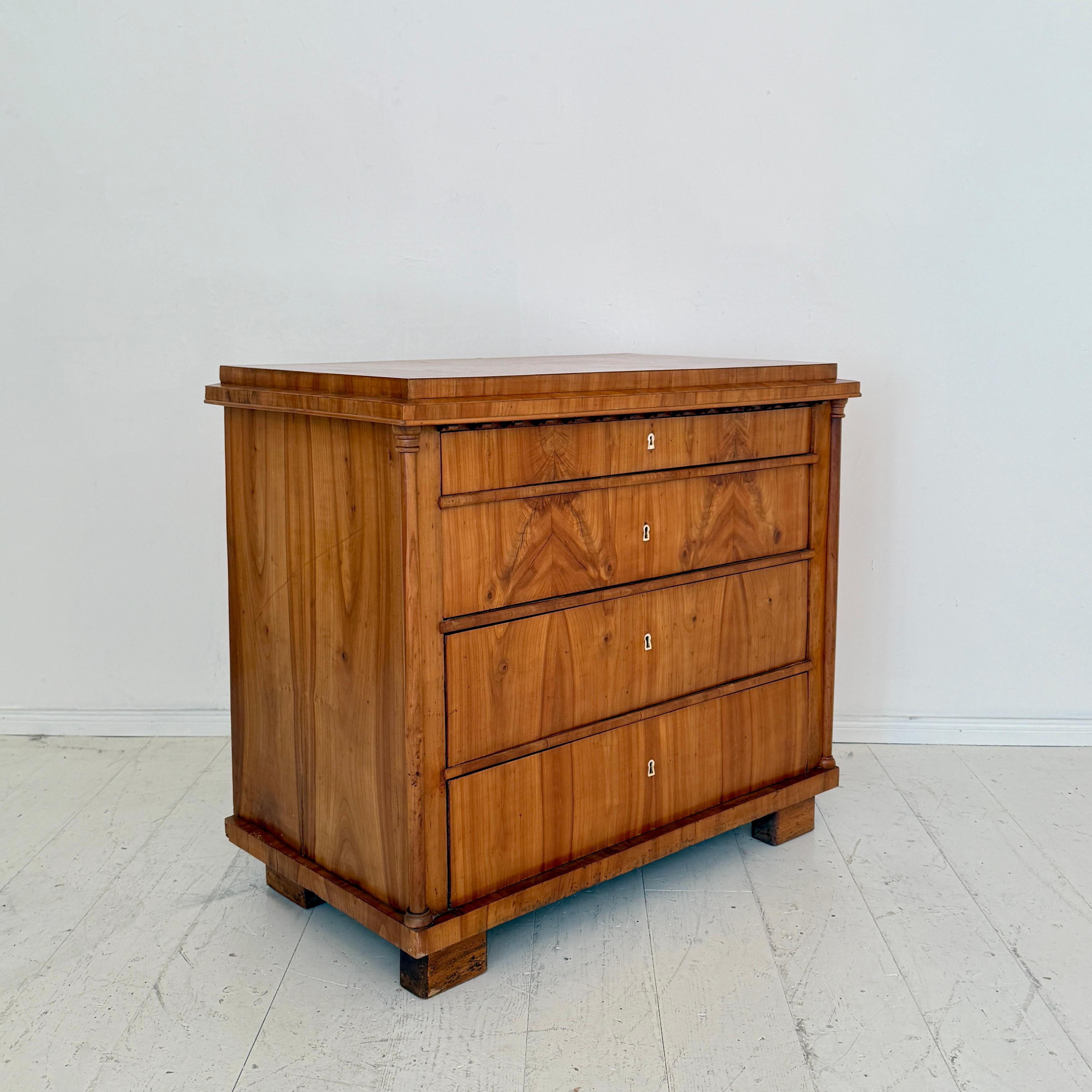 An exceptional German Biedermeier chest of drawers, crafted circa 1820 in light brown cherrywood. This finely proportioned piece reflects the elegance and restraint of early 19th century design, with its clean lines enhanced by subtle decorative