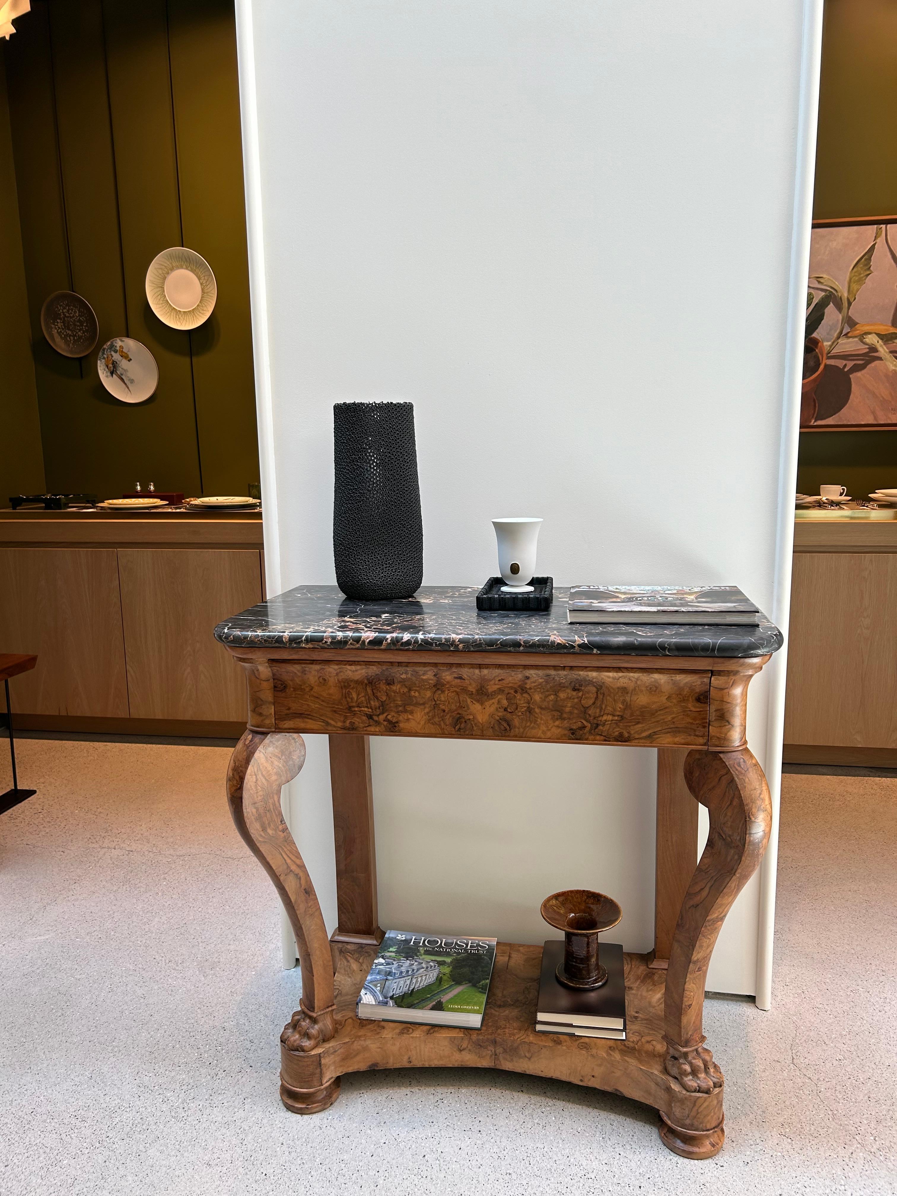 This stunning 19th-century Biedermeier console table, originating from Bohemia, showcases exceptional craftsmanship with its walnut burl veneer. Featuring a functional drawer and distinctive figurative legs, this piece embodies the elegance of the