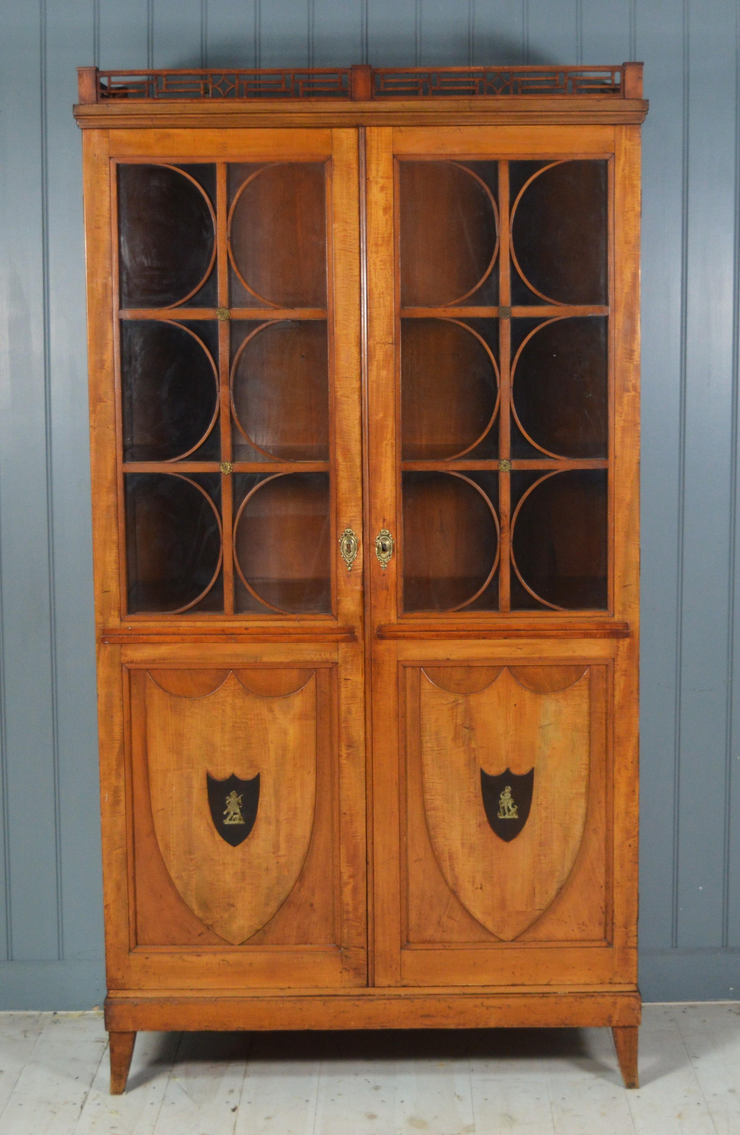  A superb Satinwood display cabinet in the Biedermeier style with shield panels on the lower case. It has 2 drawers on the inside made of pitch pine with ring drop handles, the carcass is made of good quality pine probably Douglas fir.  The whole