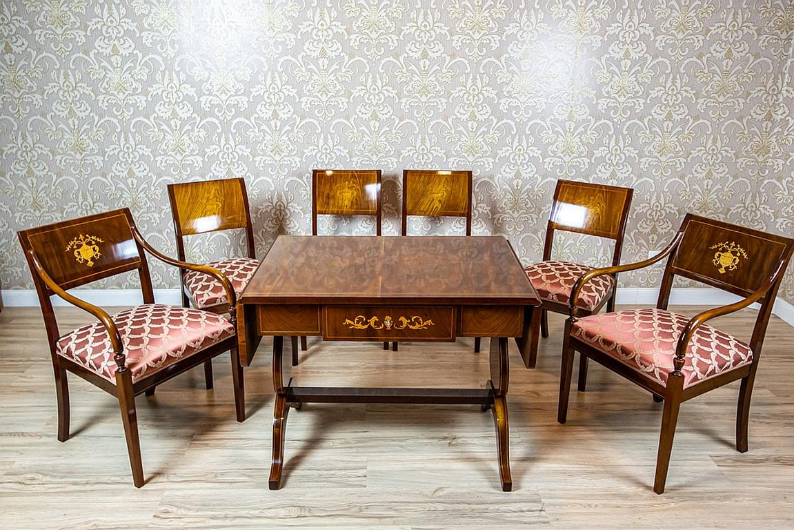 We present you a living room set composed of a table, four chairs, and two armchairs.
The whole was manufactured in the second half of the 19th century.
The set is of simple, elegant forms typical for the period.
The drop-leaf table with a