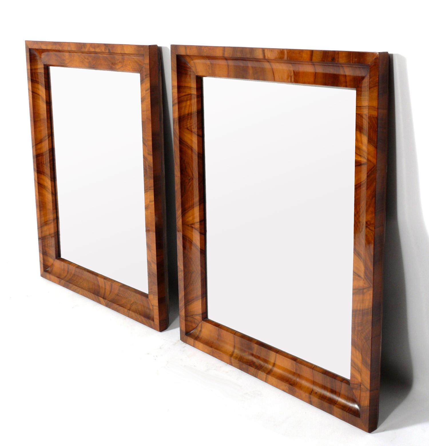 19th century Biedermeier mirrors, Germany, circa 19th century. These are extremely well made with beautifully grained bookmatched walnut frames. They are priced at $2800 each or $5000 for the pair. They each measure an impressive: 36
