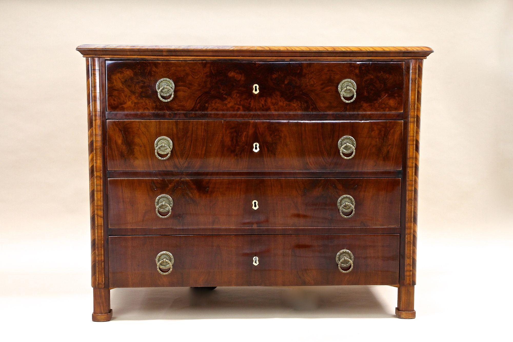 Remarkable 19th century nutwood chest of drawers coming from the capital city of traditional Biedermeier furniture: Vienna, Austria. This fresh restored Biedermeier commode was elaborately made around 1840 and impresses with an amazing grain. The