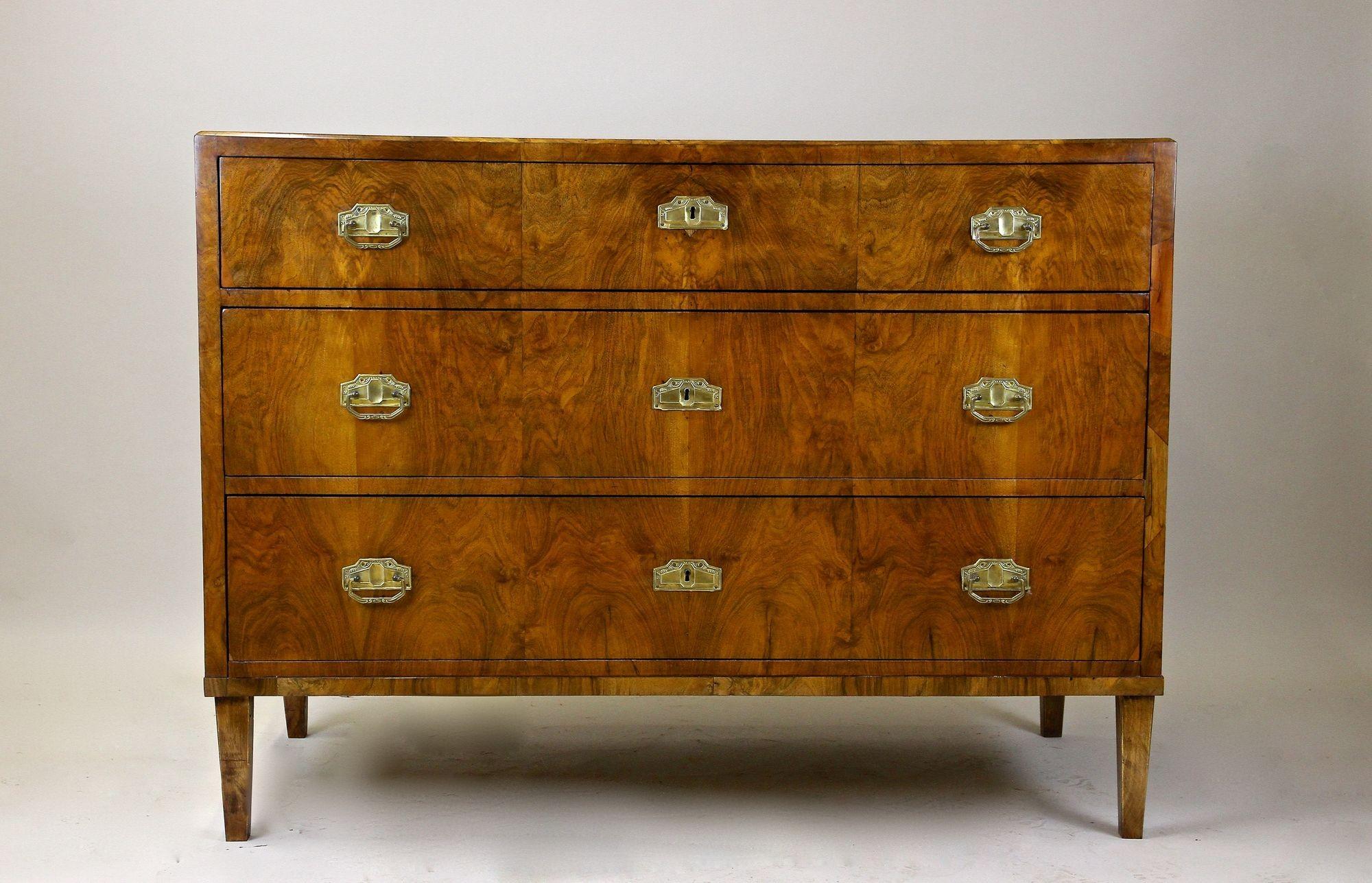 Remarkable Austrian Biedermeier chest of drawers/ writing commode veneered with finest nut wood from the period in Austria around 1840. Impressing with an absolutely amazing looking grain, this completely restored four drawer commode is a real