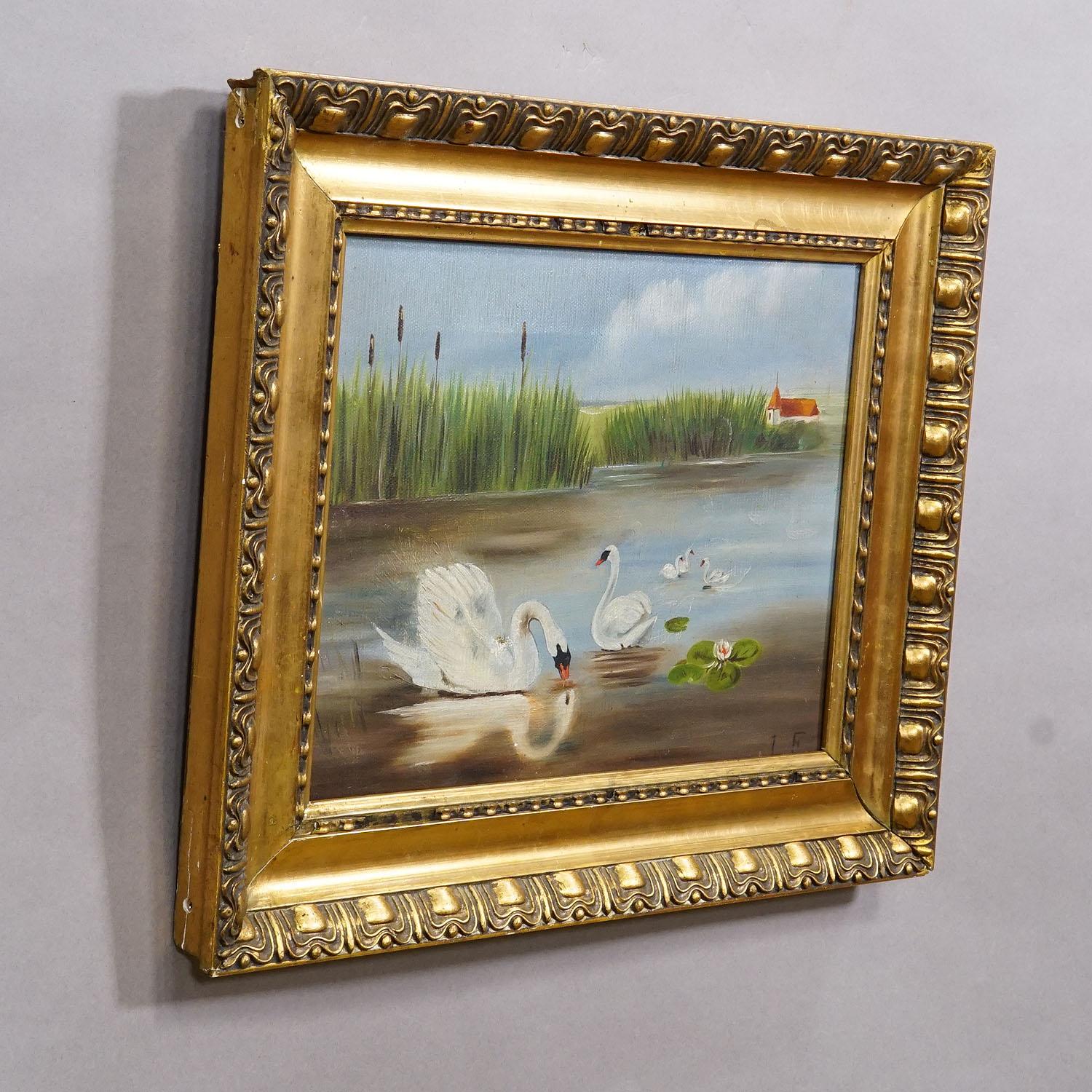19th Century Biedermeier Painting with Swans on a Lake

This antique oil painting, set in a wooden gilded frame, was painted on canvas in the late 19th century. It depicts a peaceful waterscape featuring a swan family in a natural setting with a